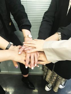 Student bonding exercise, students have placed hands of top of each other.