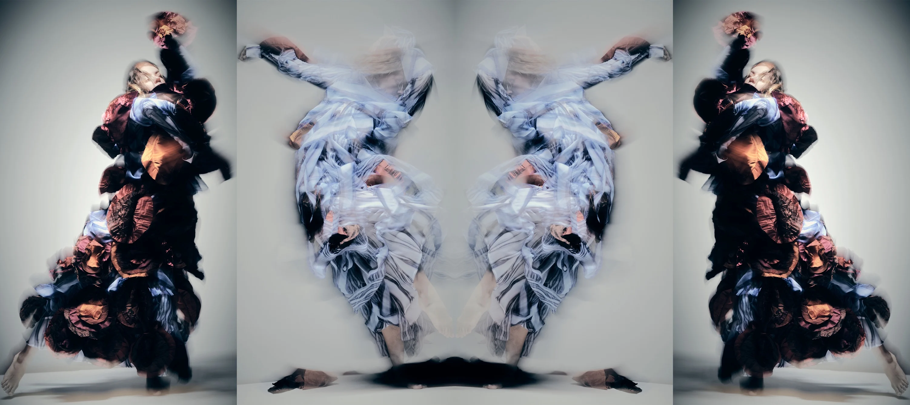 Dancers, blurred, in large costumes.