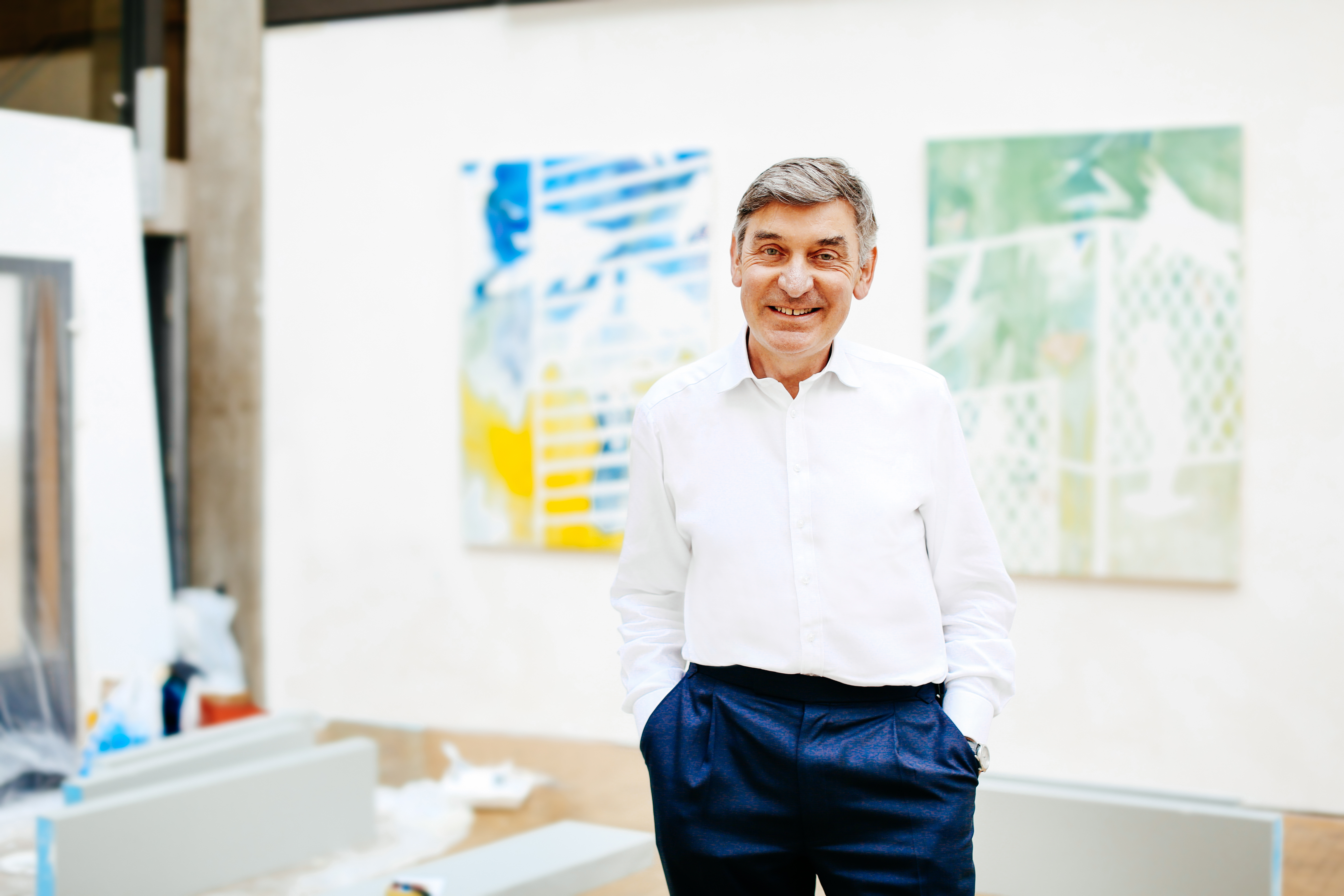 UAL Vice Chancellor Nigel Carrington pictured in front of student artwork