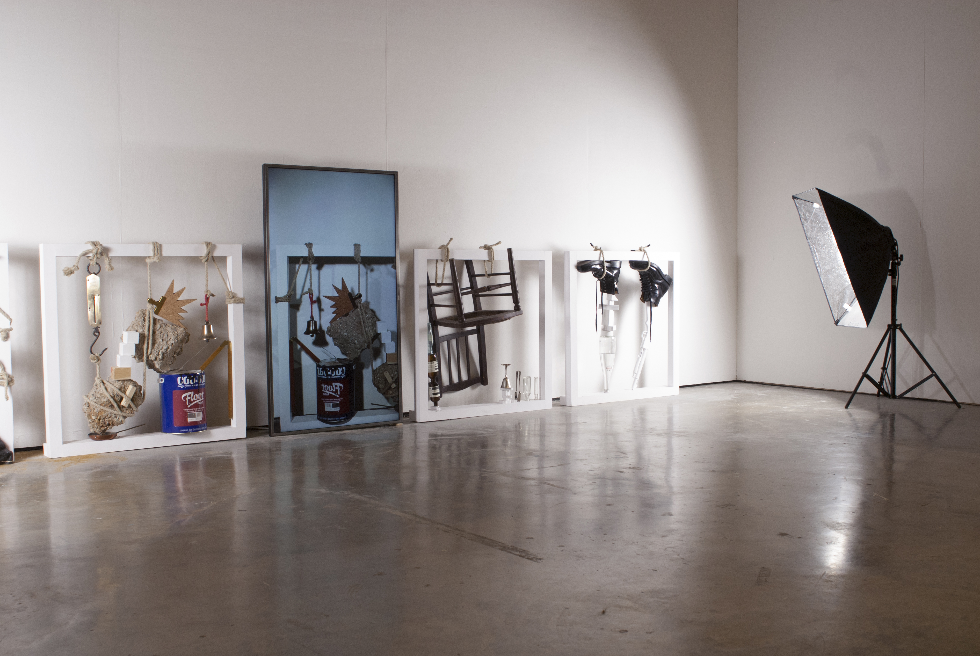 A series of sculptures leant against a wall