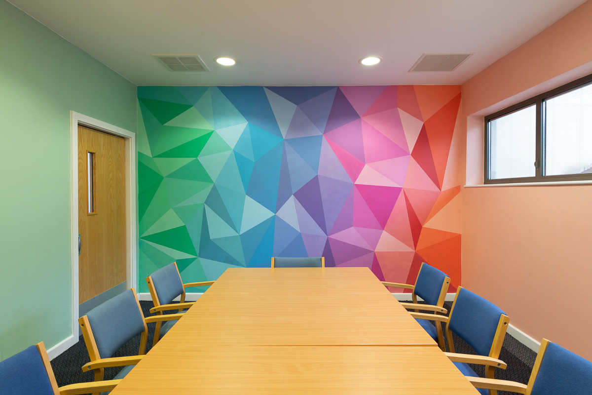 Charley Peters' colourful artwork on display in the Tribunal Room at Bluebird House.