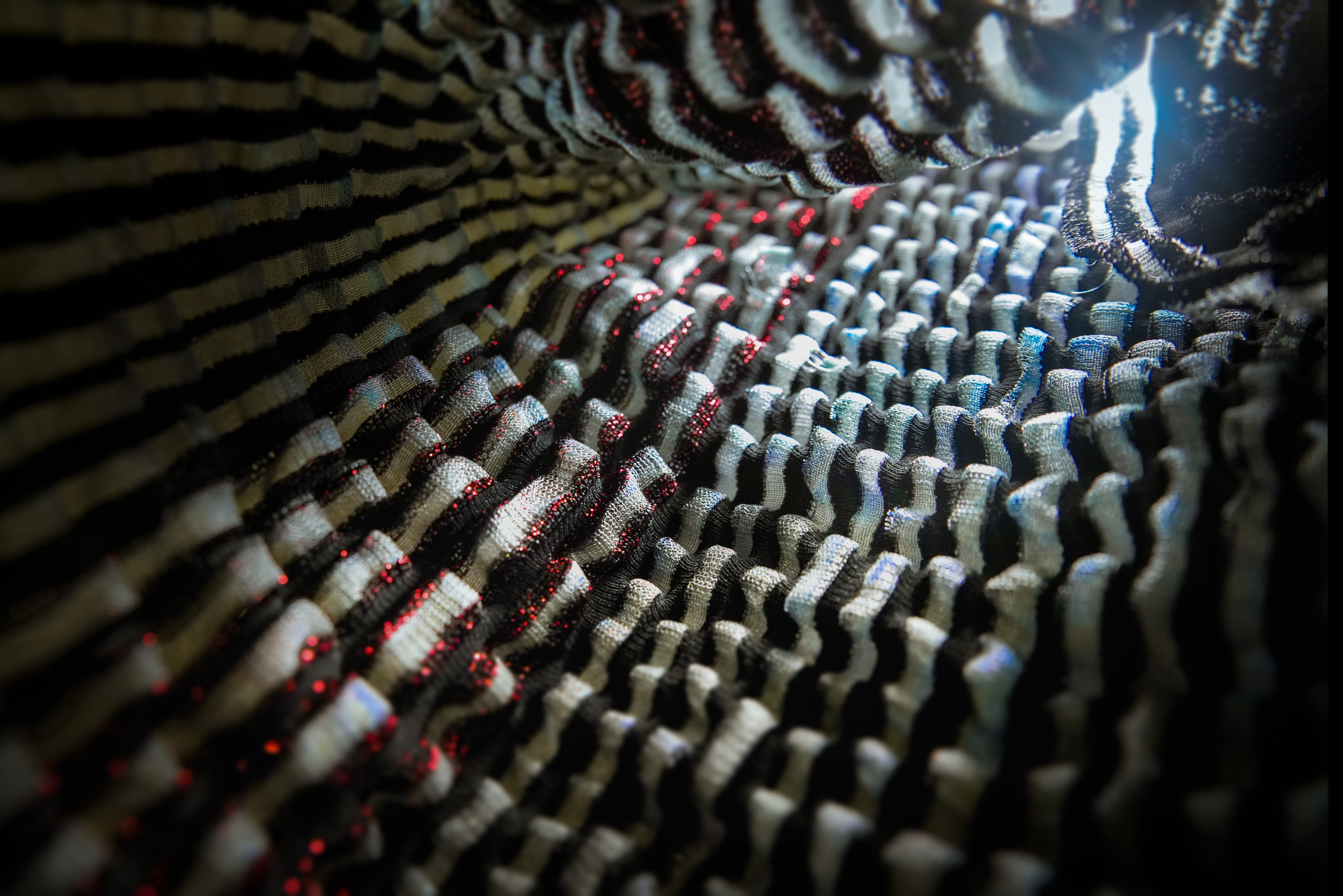 Close-up of knit patterns in grey and bright red.