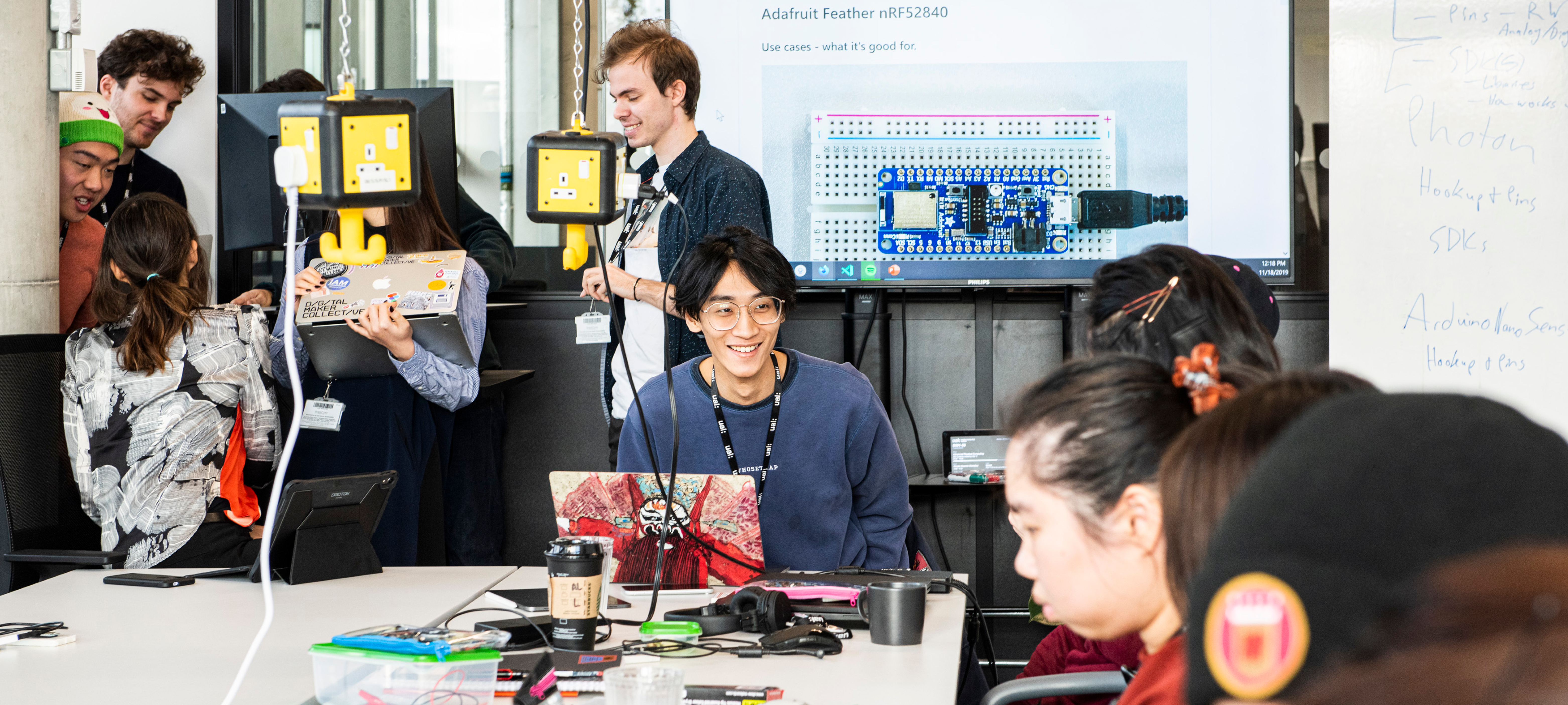 Students working in the studio surrounded by computing equipment