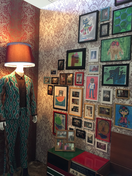 Image of the mannequin wearing a suit with a lampshade for a head.