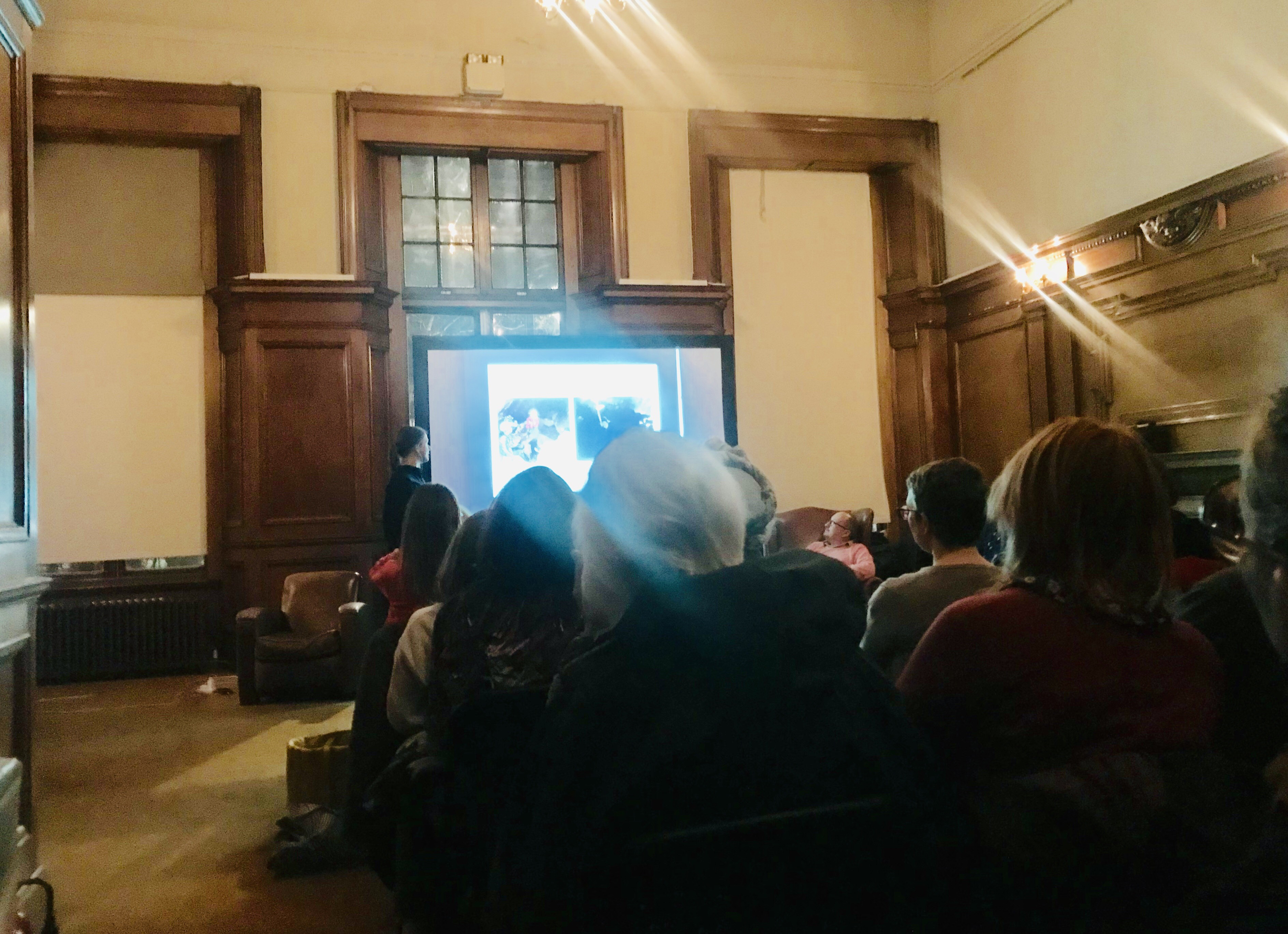 A woman presents in front of an audience