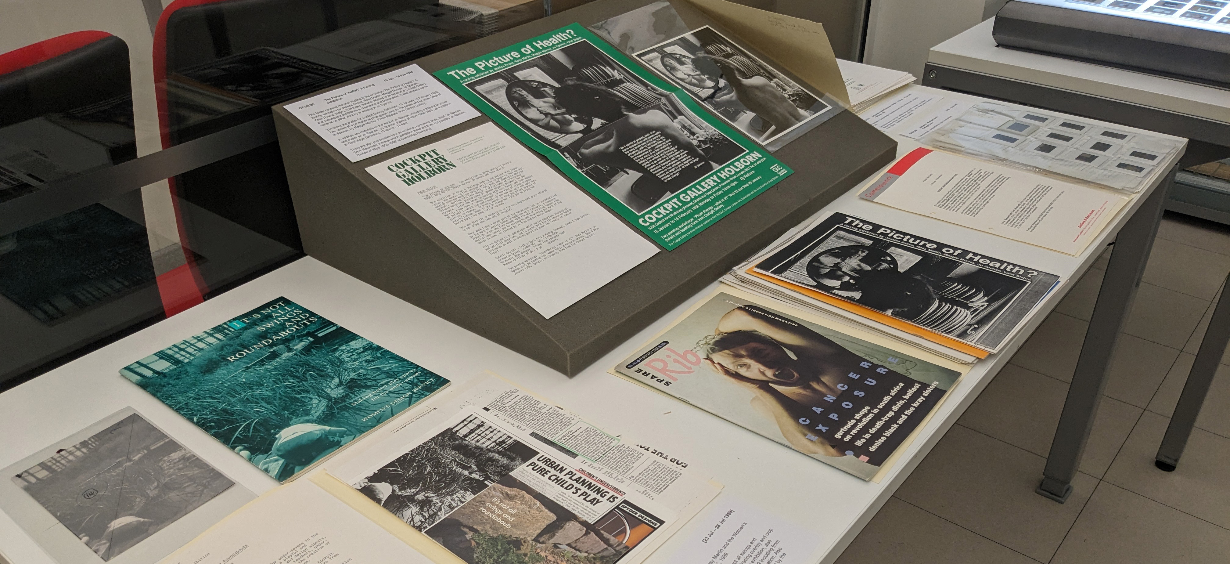 Colour photograph of a display of archival material from photography galleries on a table