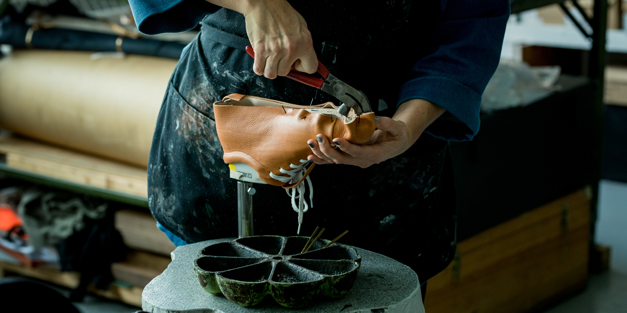 Niki making leather shoes in her workshop