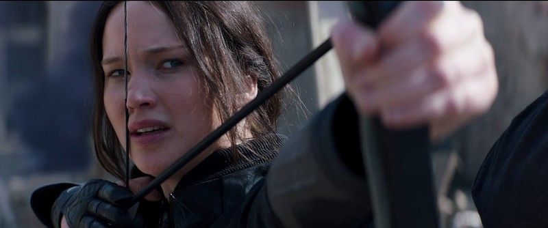 Actor Jennifer Lawrence holding a bow and arrow as Katniss Everdeen in film The Hunger Games: Mockingjay - Part 2 (2015).