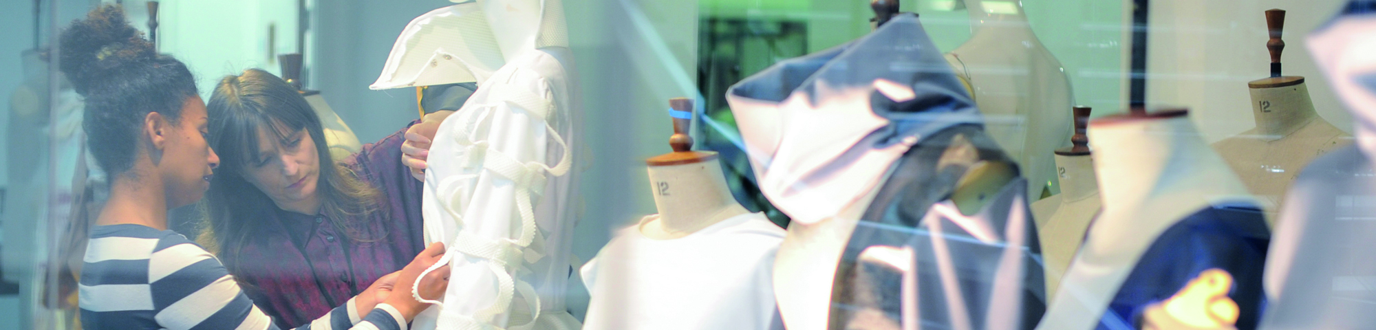 A student and tutor preparing a window display