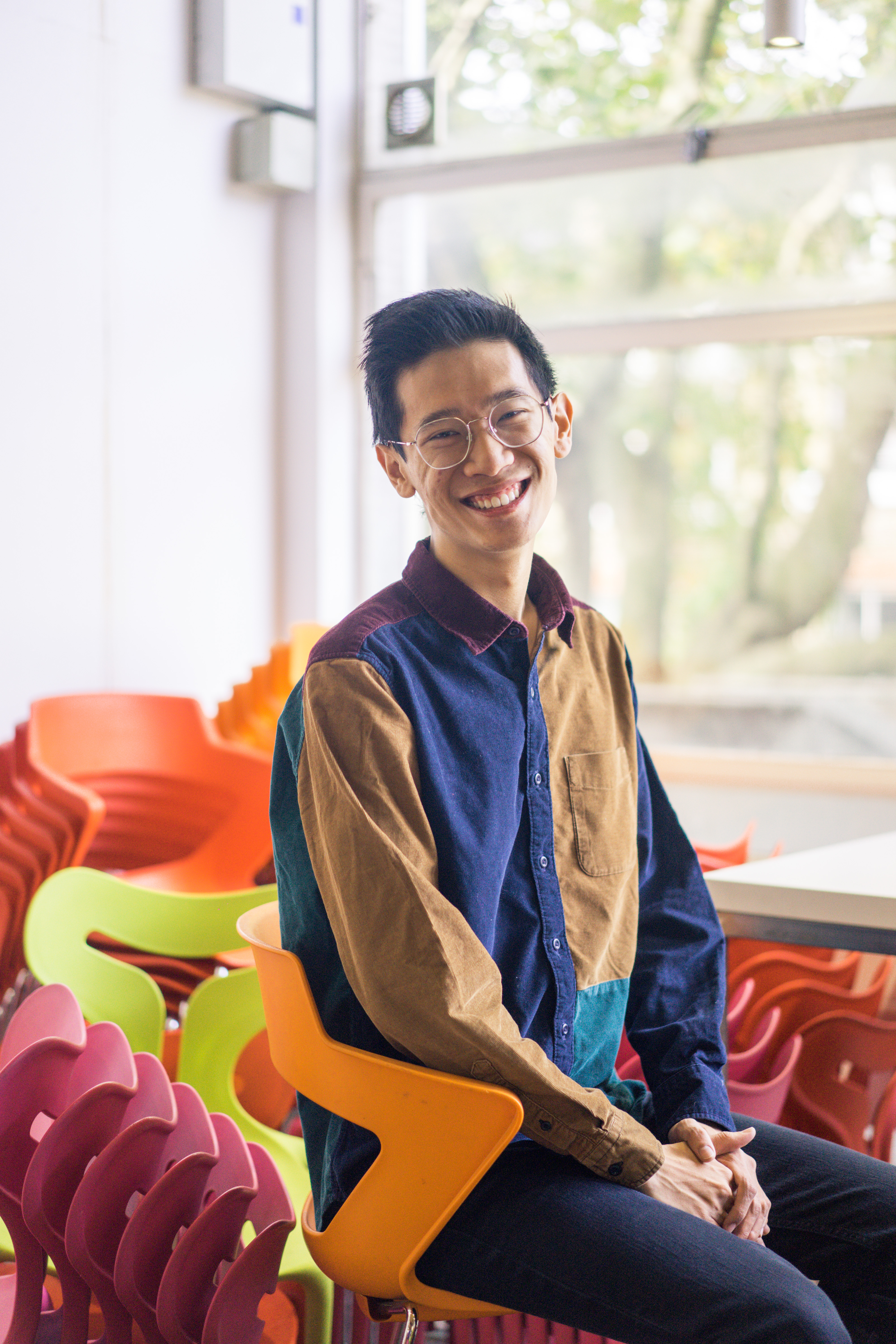 Male sitting in front of a window 
