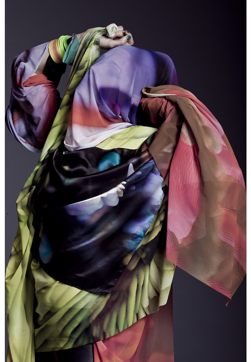 A figure is draped in scarves.