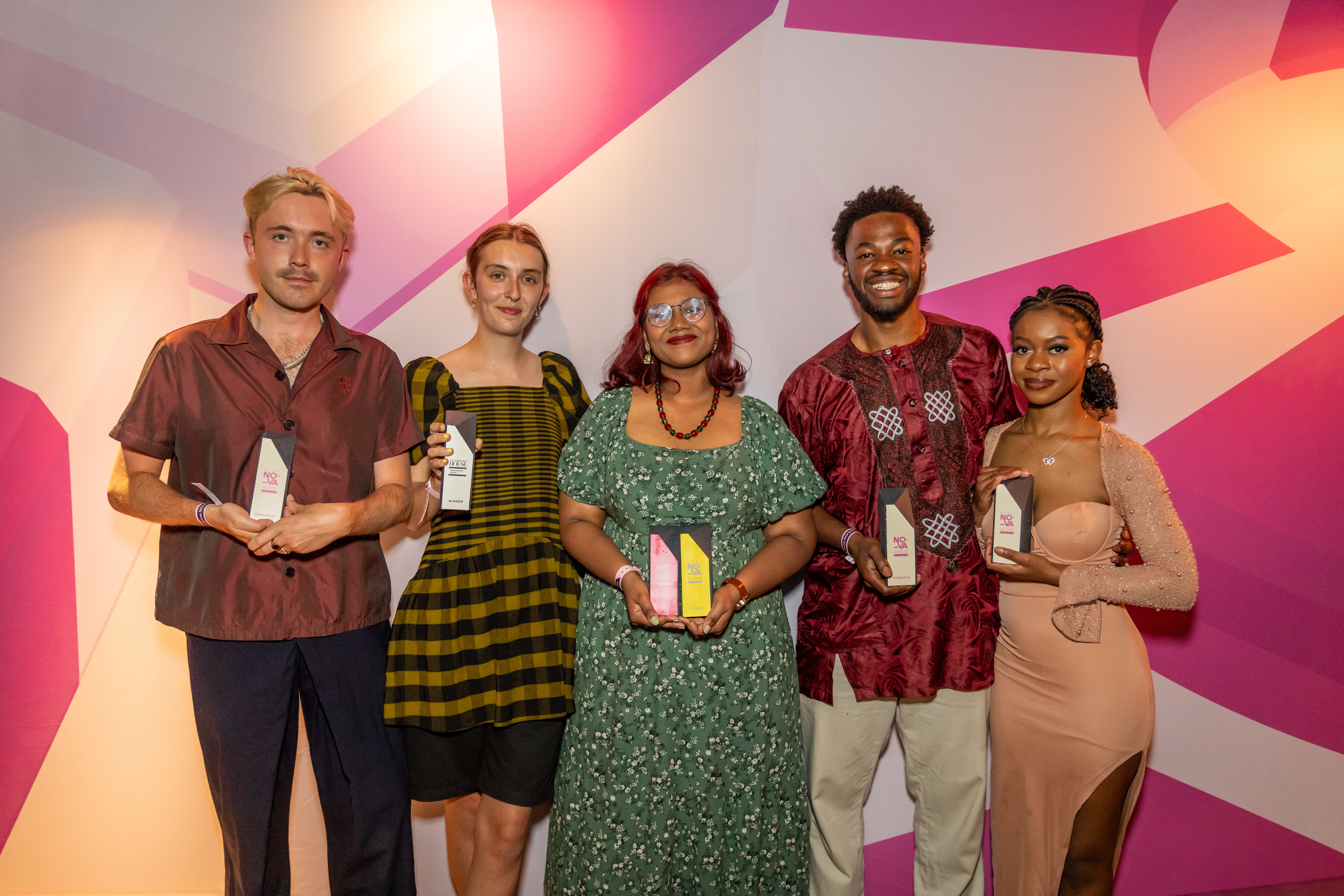 A group shot of the five winners with their awards and NOVA branding behind them