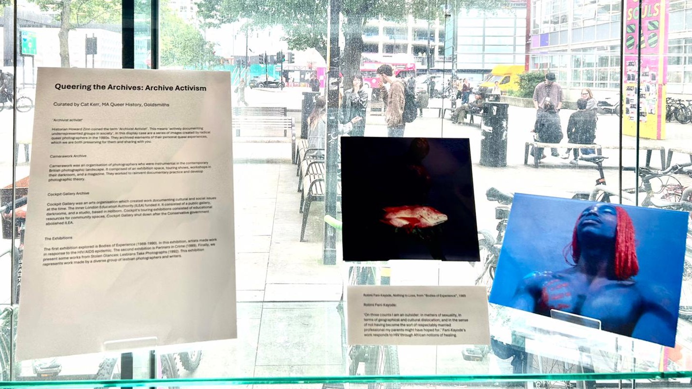 Colour photograph of an exhibition display case with colourful photographs
