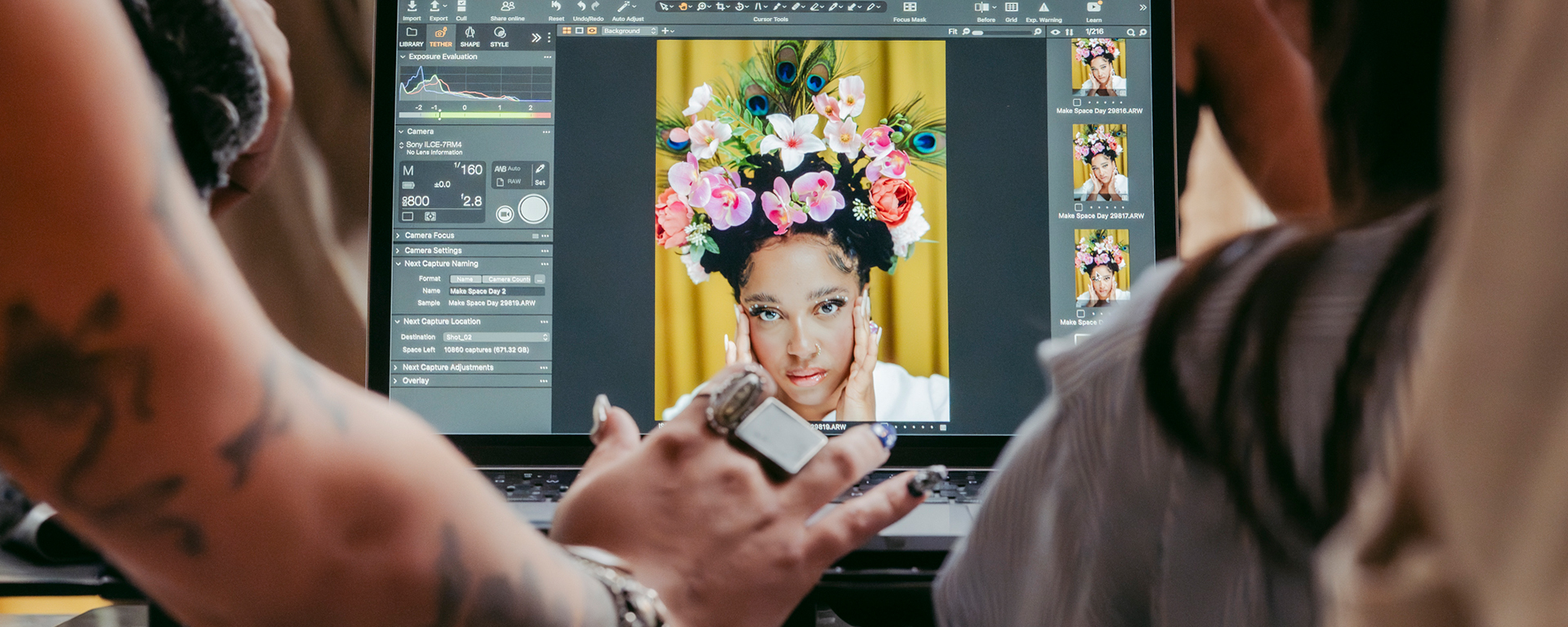 Behind the scenes photograph of students looking at a photoshop mock-up.