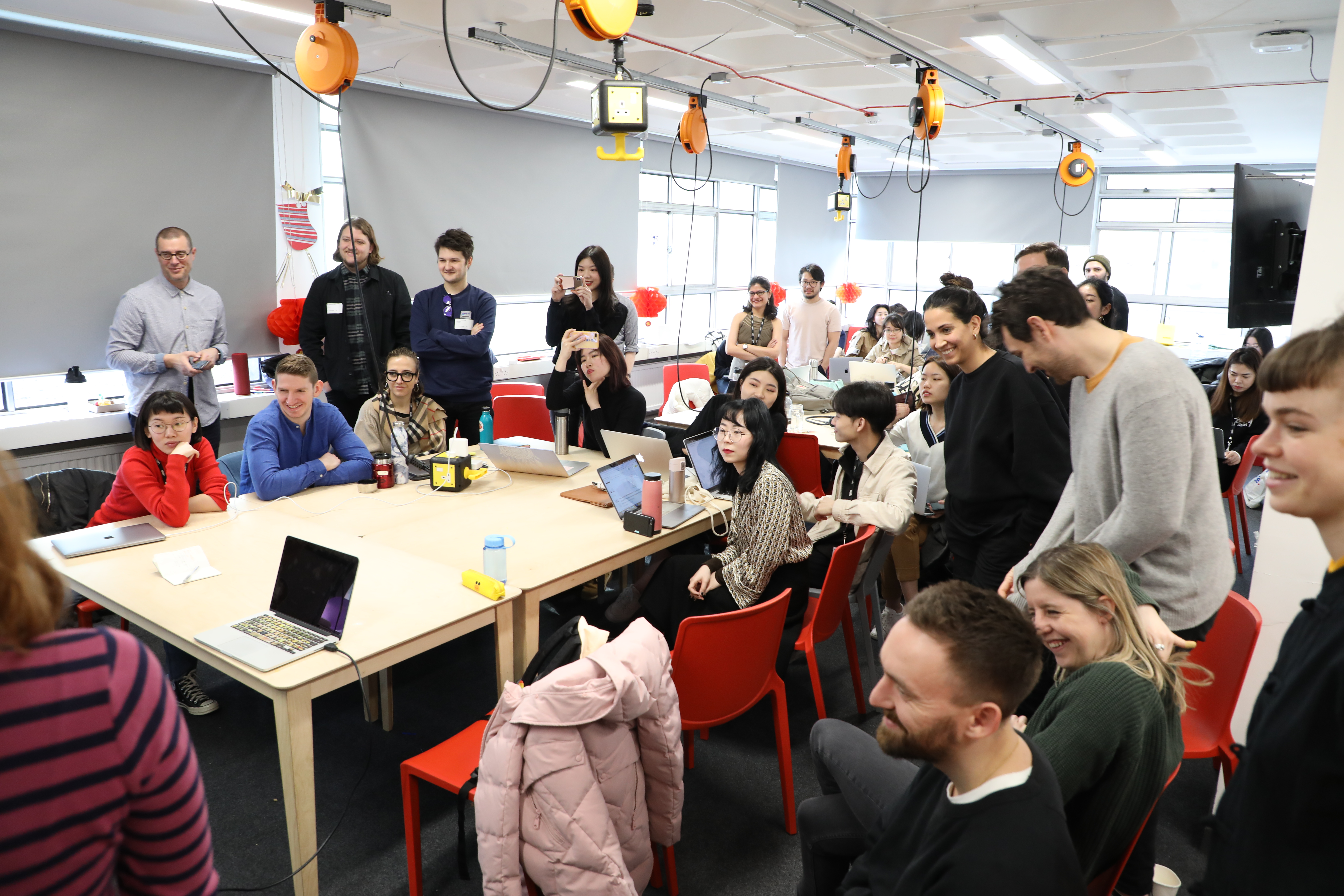 Photo of UX Design students hearing design proposals.