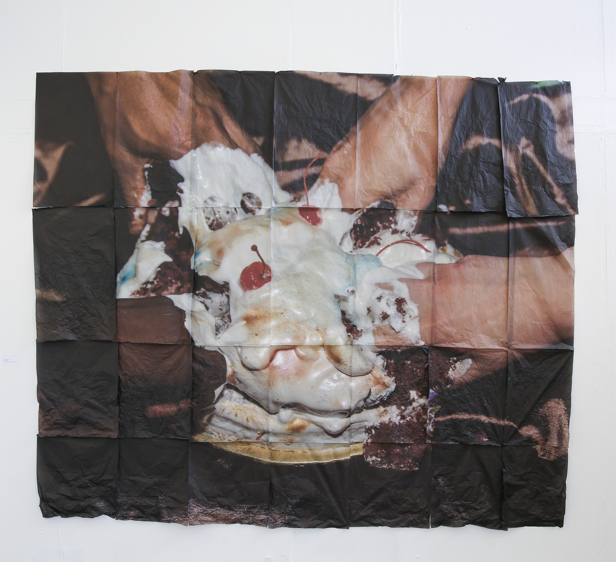 A print on fabric of people with their hands stuck into an iced cake