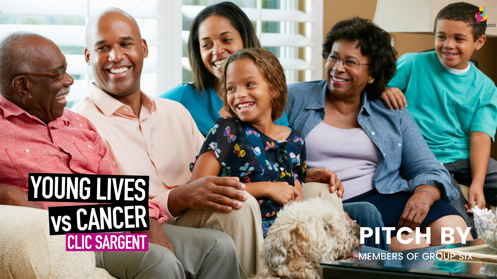 An image of a smiling family sitting on a sofa.