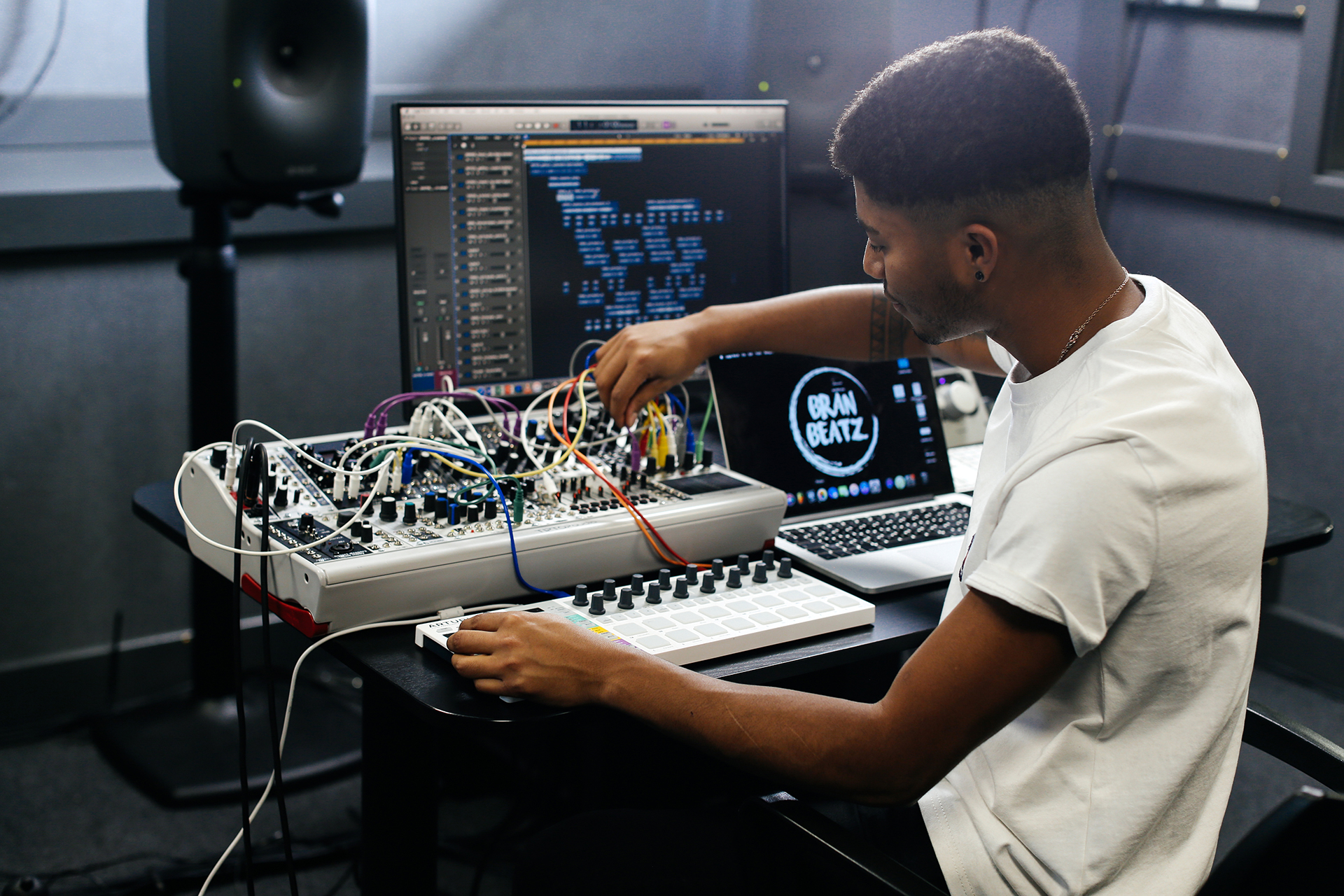 Student sitting at a mixing desk in the College sound studio
