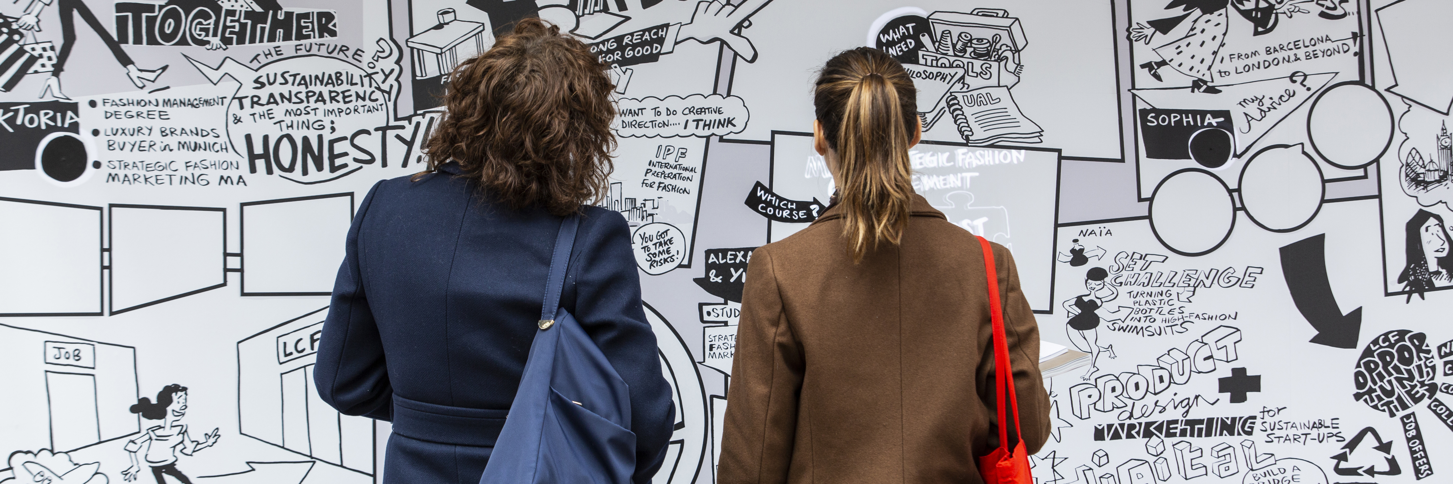Two people staring at a graffiti