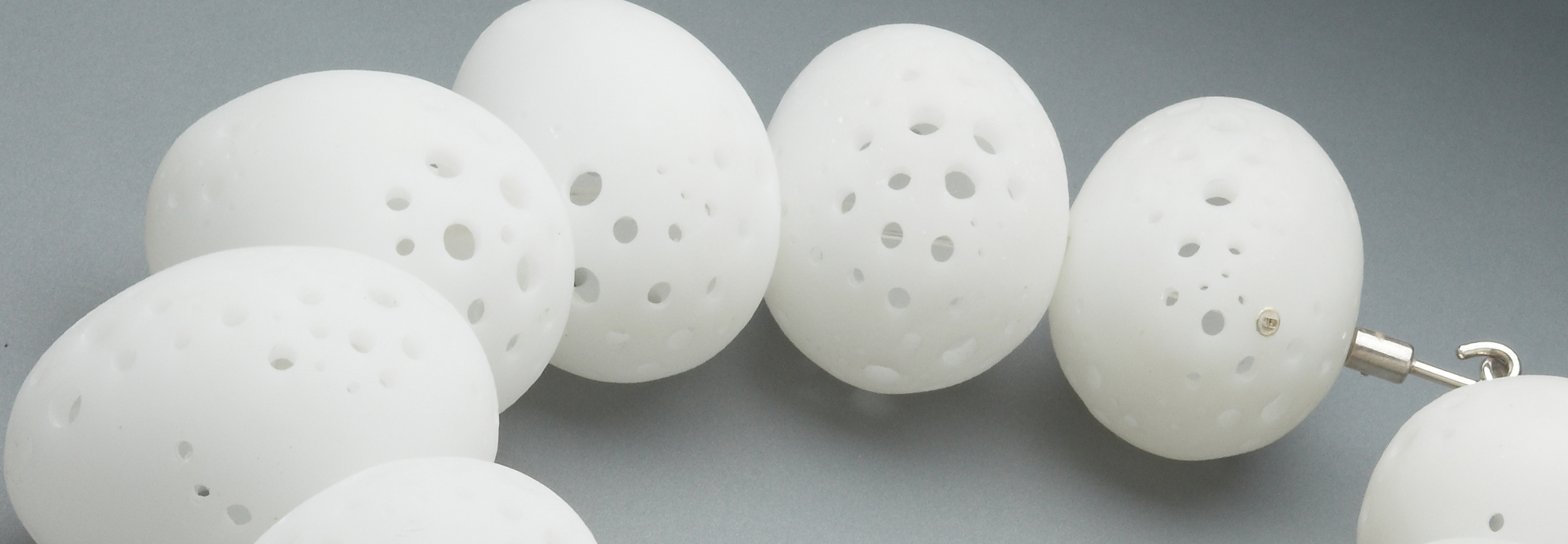 Sarah King's jewellery design, egg shaped balls with holes necklace.