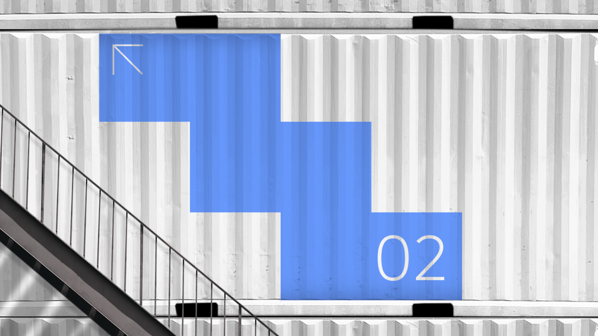 a staircase next to a blue decal which signifies the number of floors
