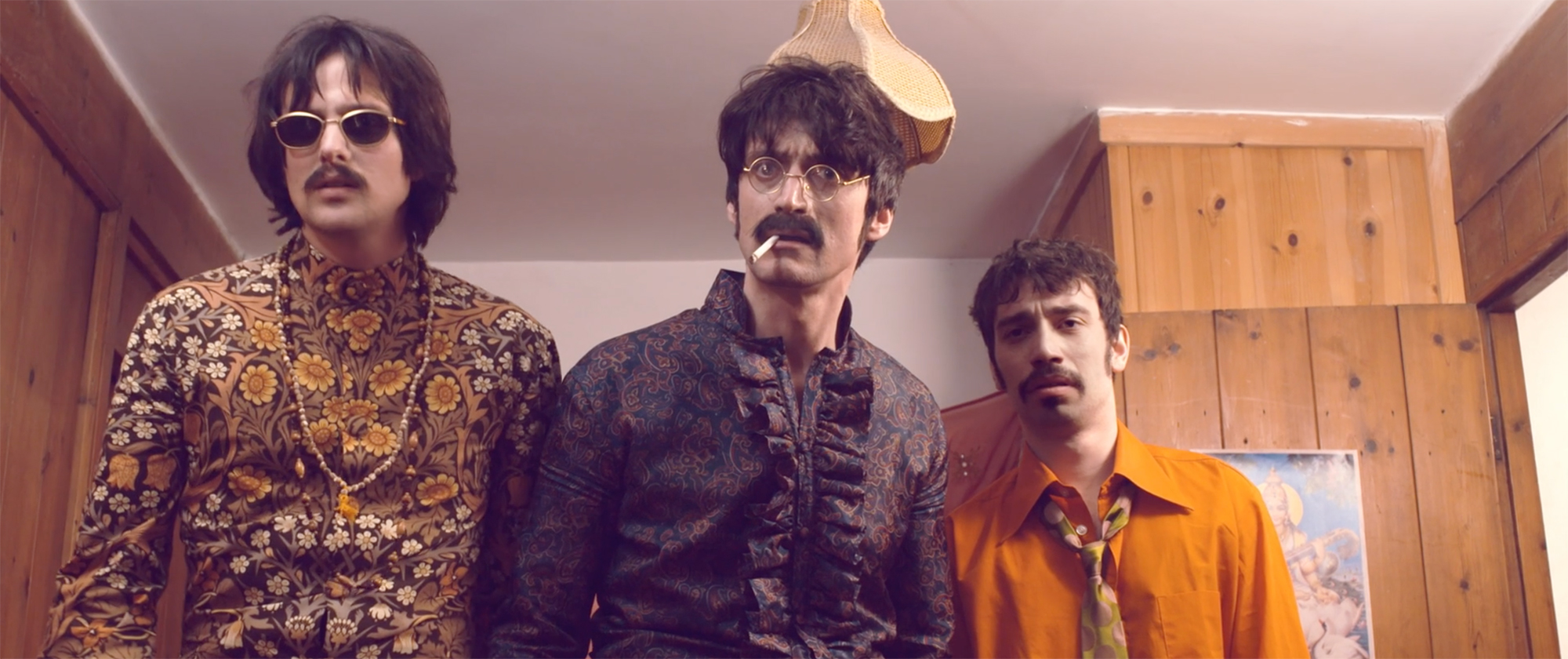 Three men resembling members of The Beatles look at the camera in a confused way.