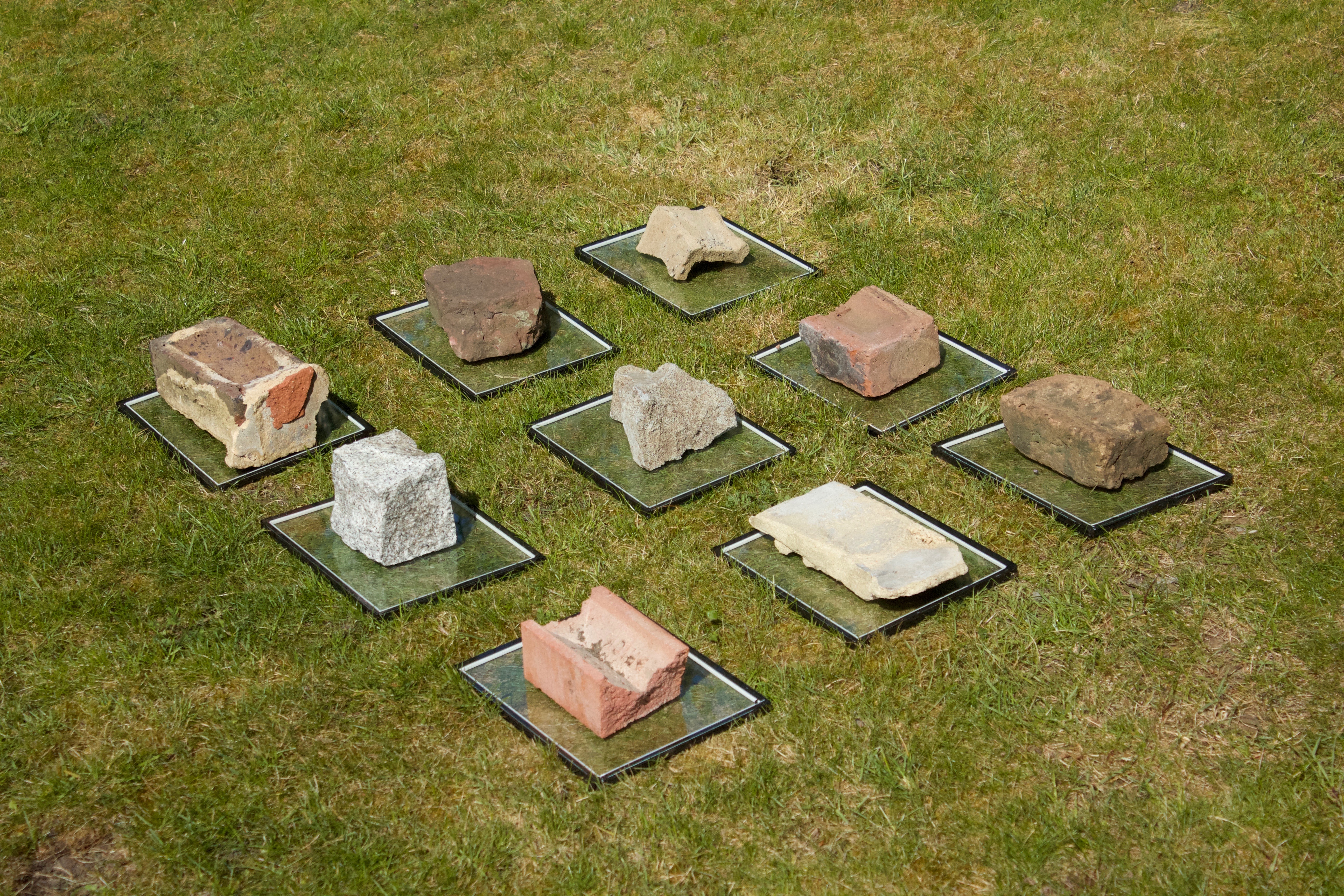 bricks on glass plates on top of grass