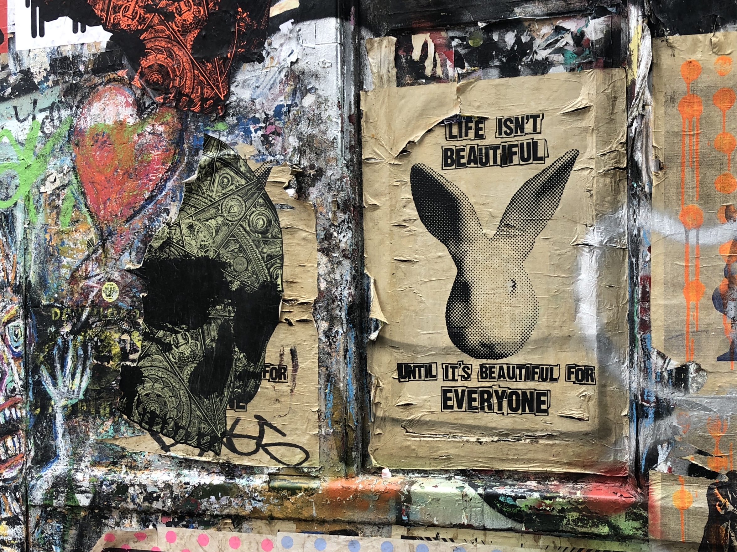 Graffitti and fly poster on urban painted wall