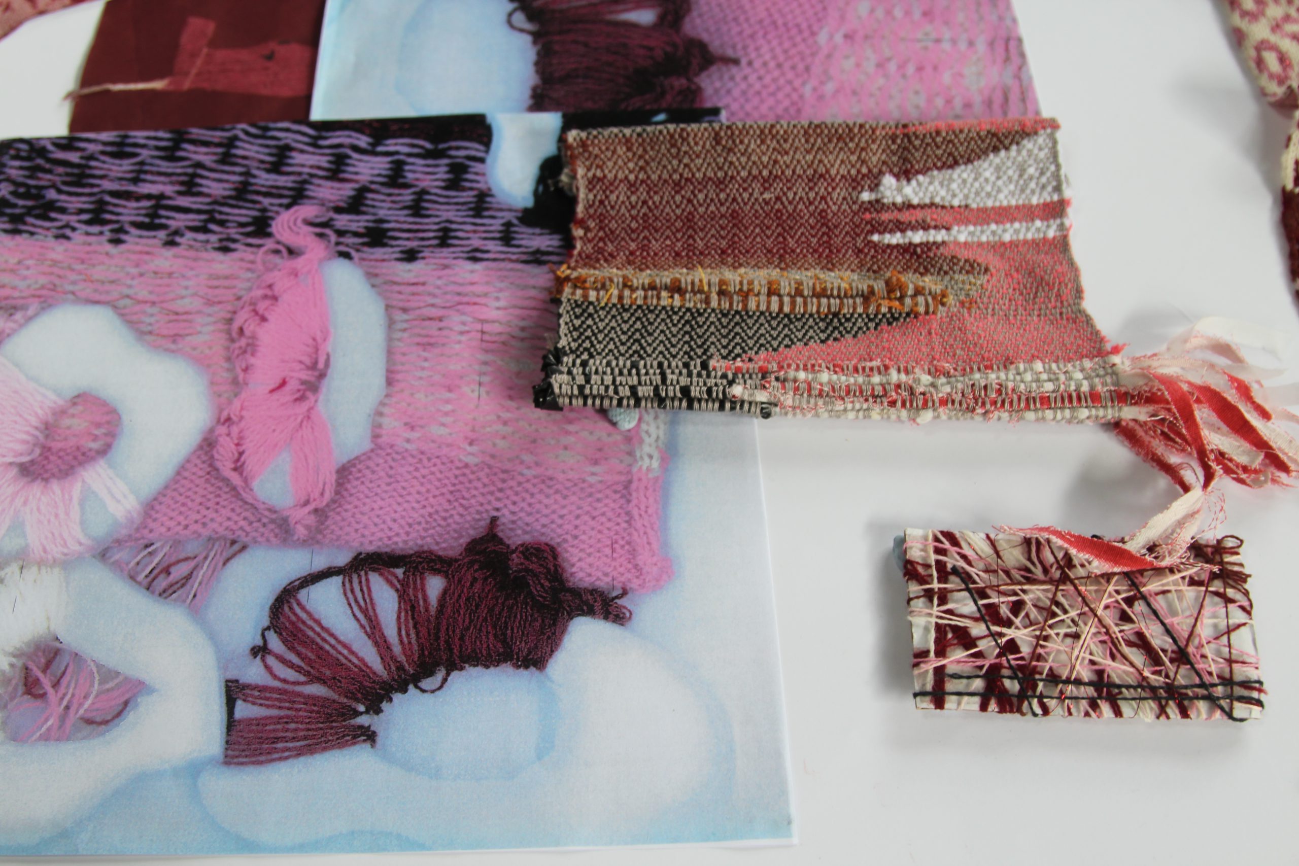 Birds eye view of textile samples in pink and maroon tones
