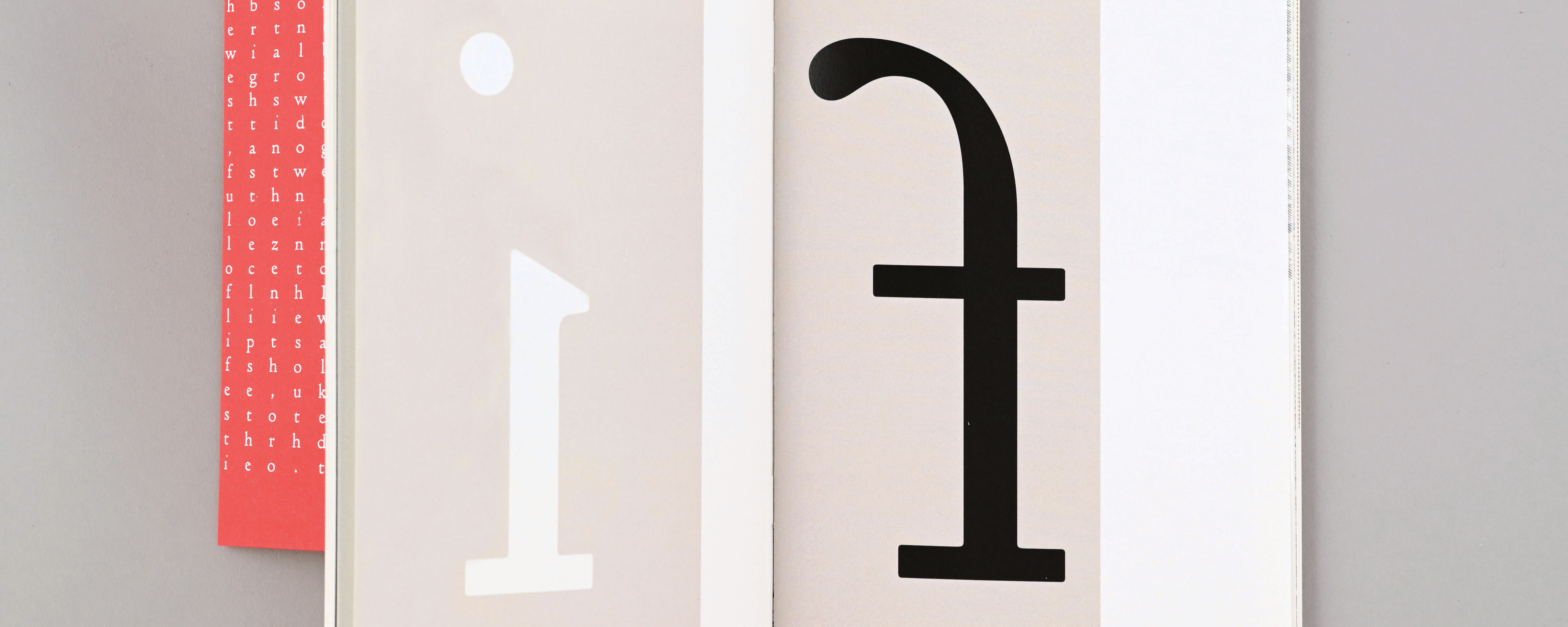 Close-up of a book, showing a large printer letter 'F'.