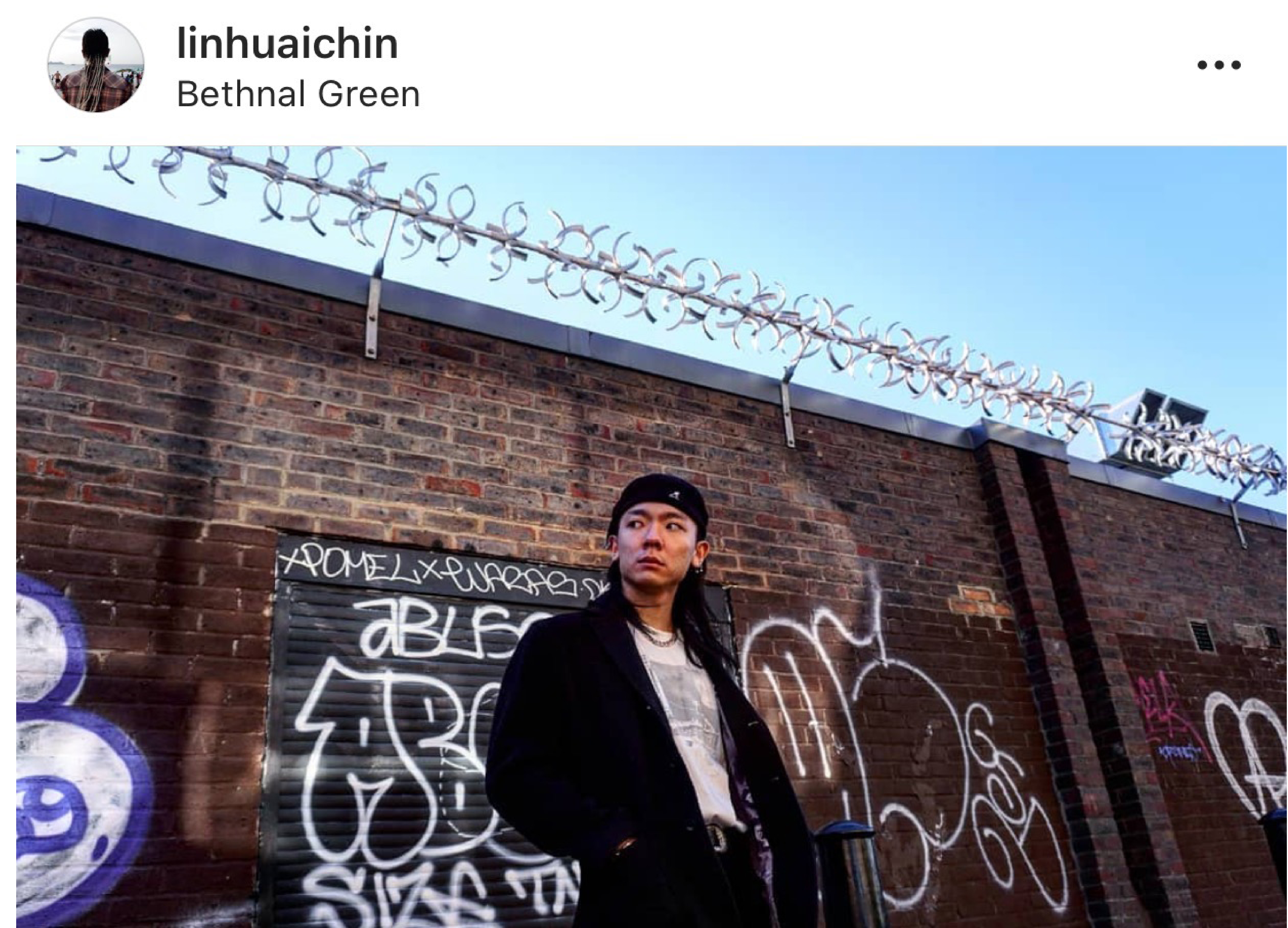 portait of asian man in front of graffiti