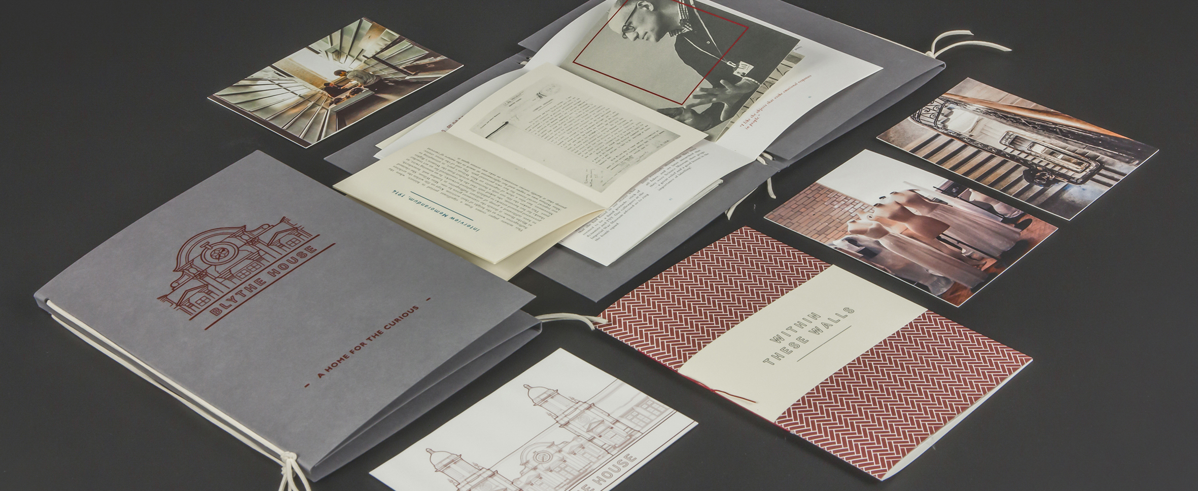 A series of publications laid out on a black table