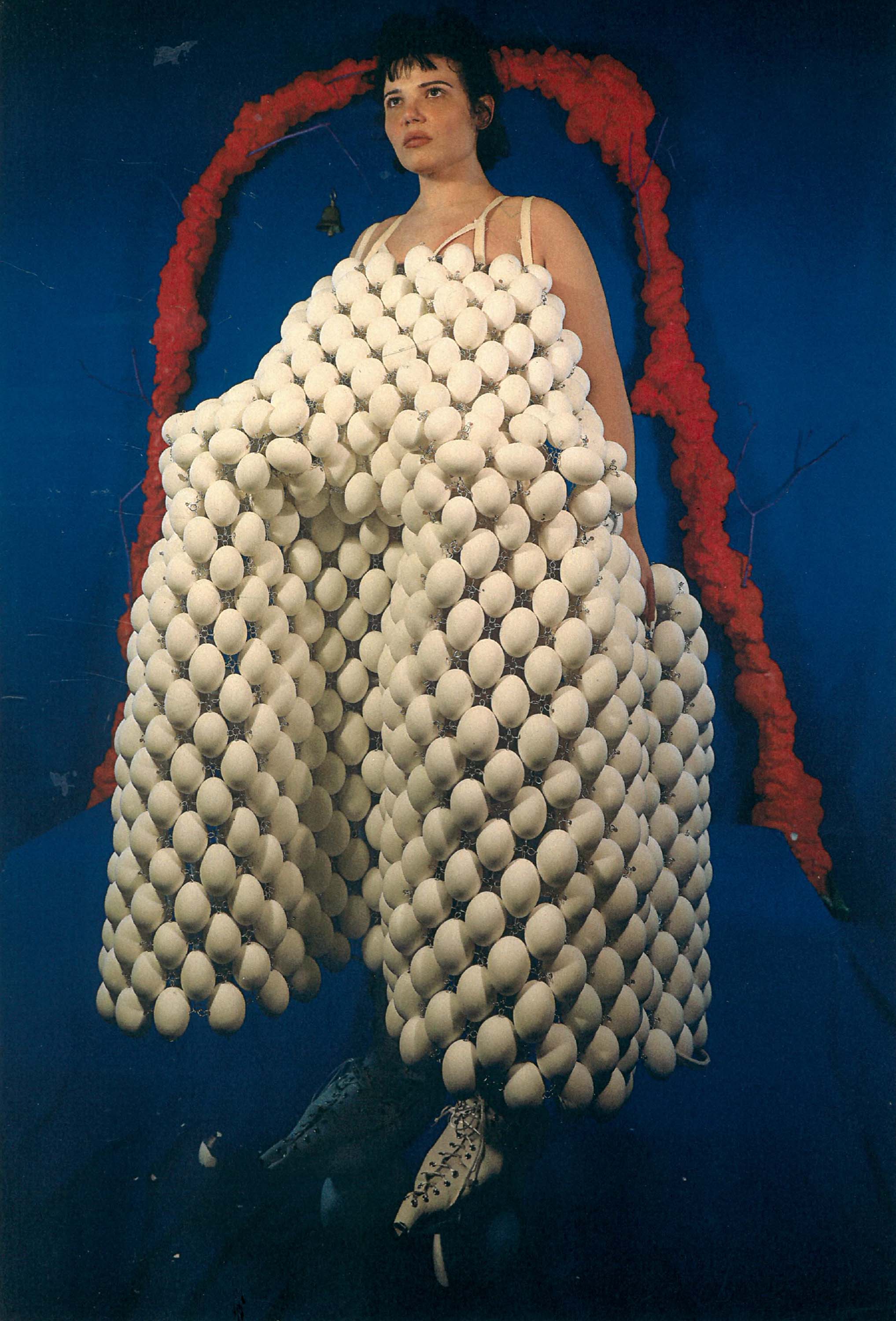 Figure wearing dress made of duck eggs