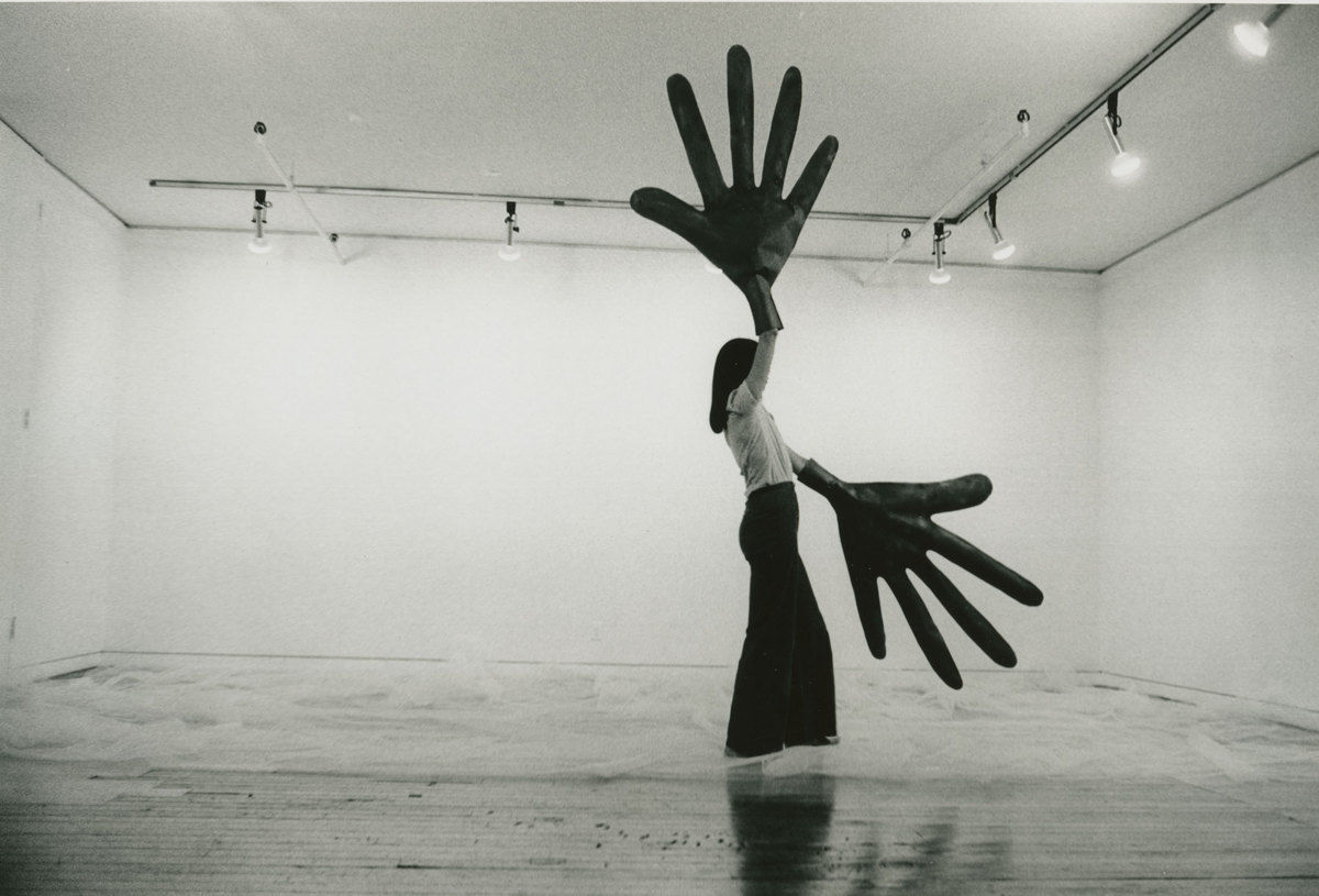 an art perfomance with gigantic gloves