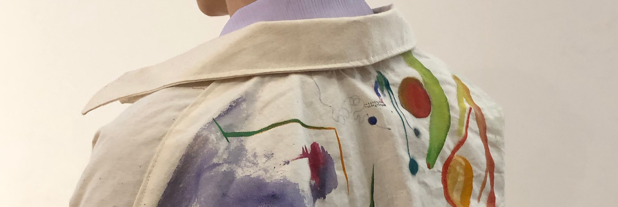 The view of a woman's back wearing a white jumpsuit which has been painted with Bauhaus-inspired designs, to be worn during the Bauhaus 100 performances in September 2019.
