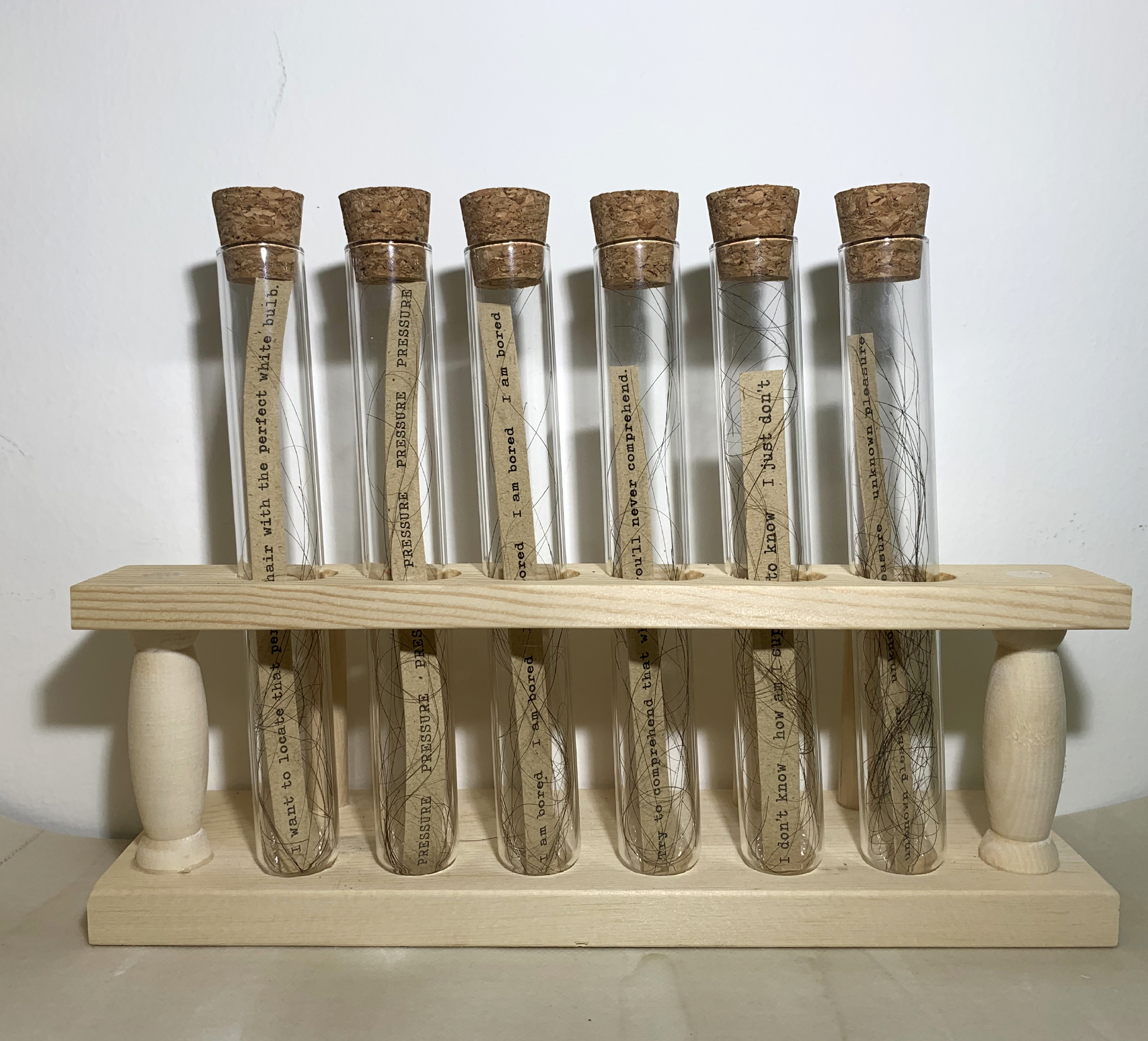 test tubes with text and hair
