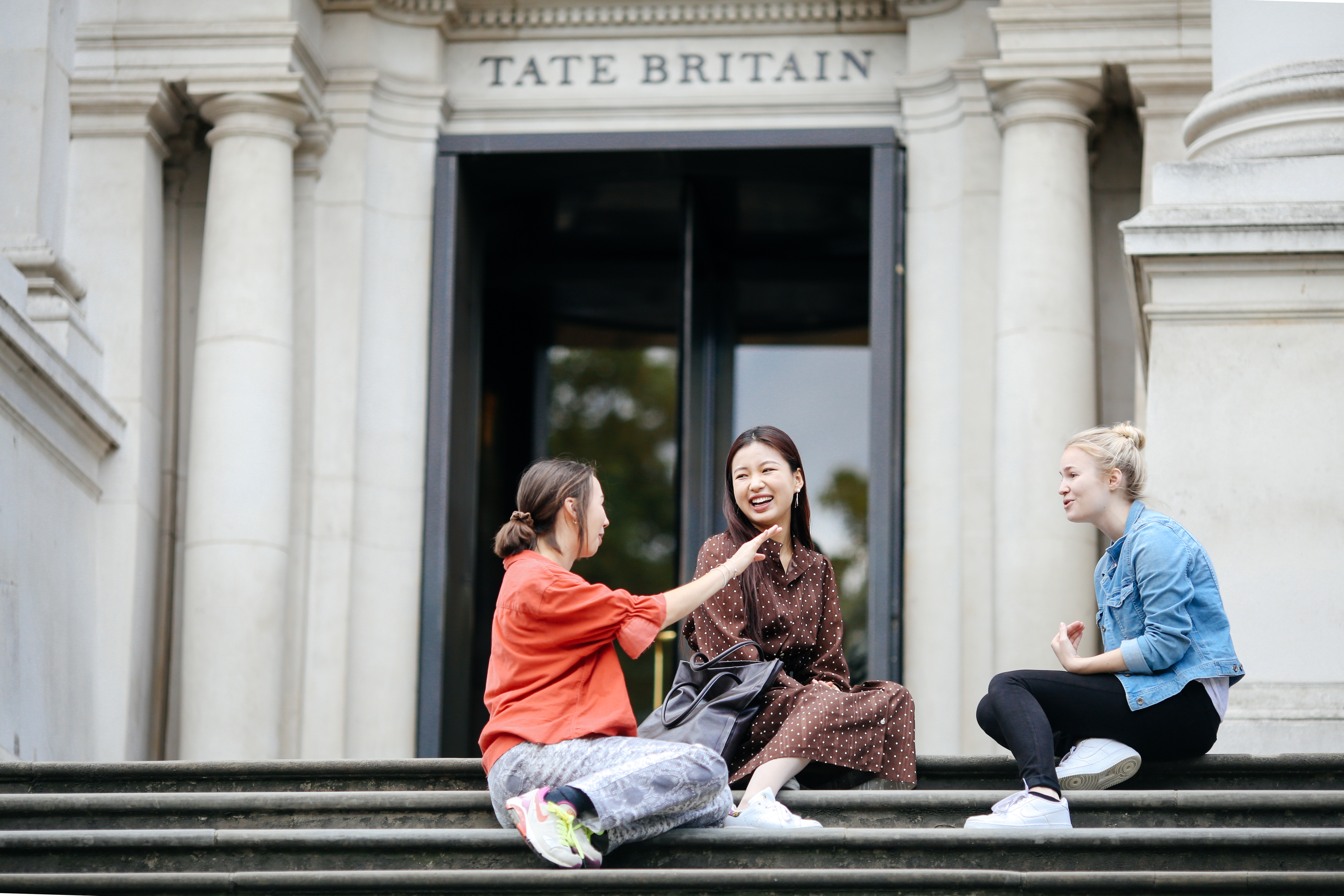 students sitting outside TATE Britain