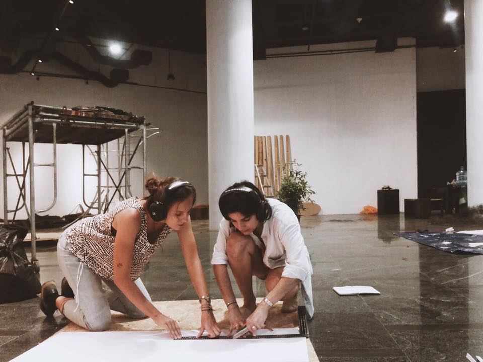 photograph of two people working together