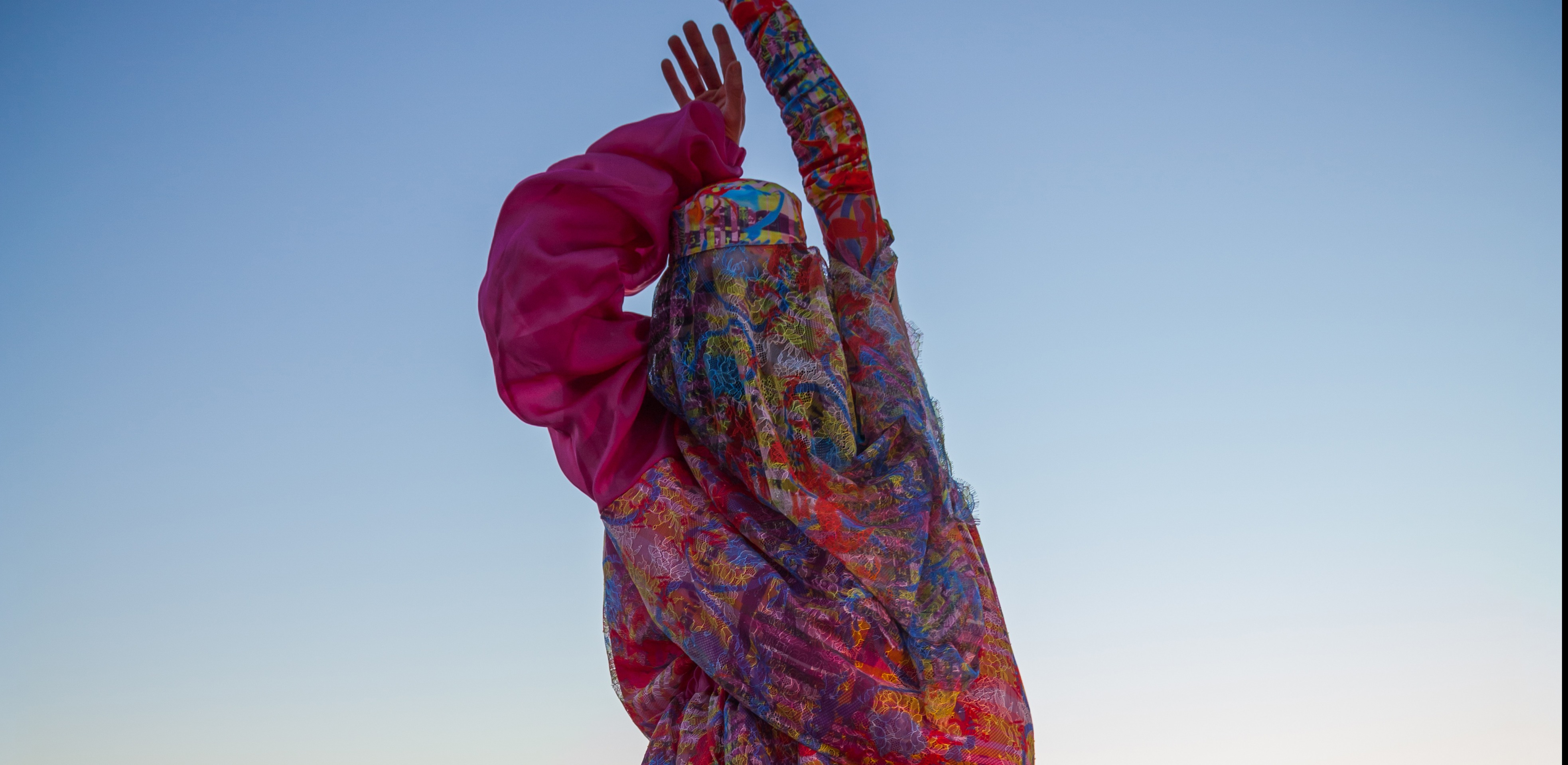 Model in colourful pink Asian dress at sunset.