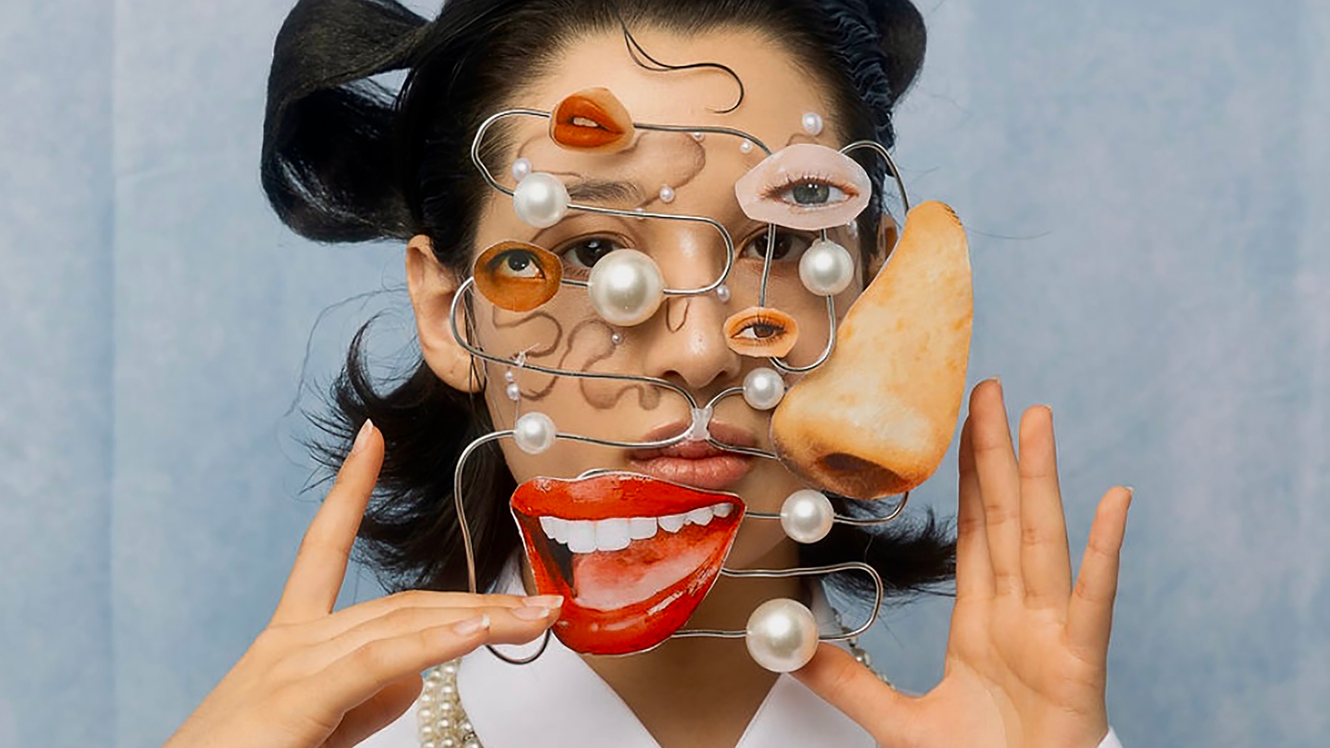 Close up of model with facial features cut out from a magazine attached to metal