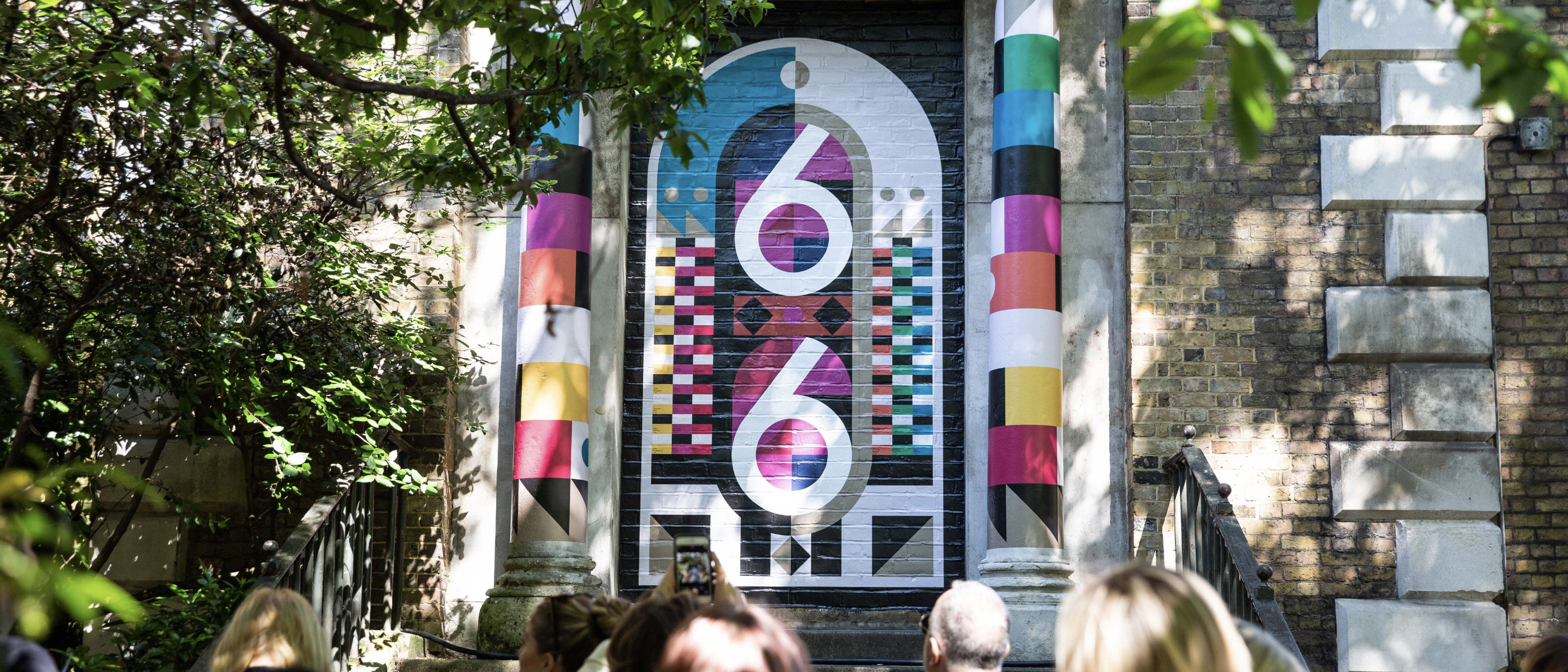 Multi-coloured mural of the number 66 painted by Alastair Ramageas as part of a project for Clerkenwell Design Week.