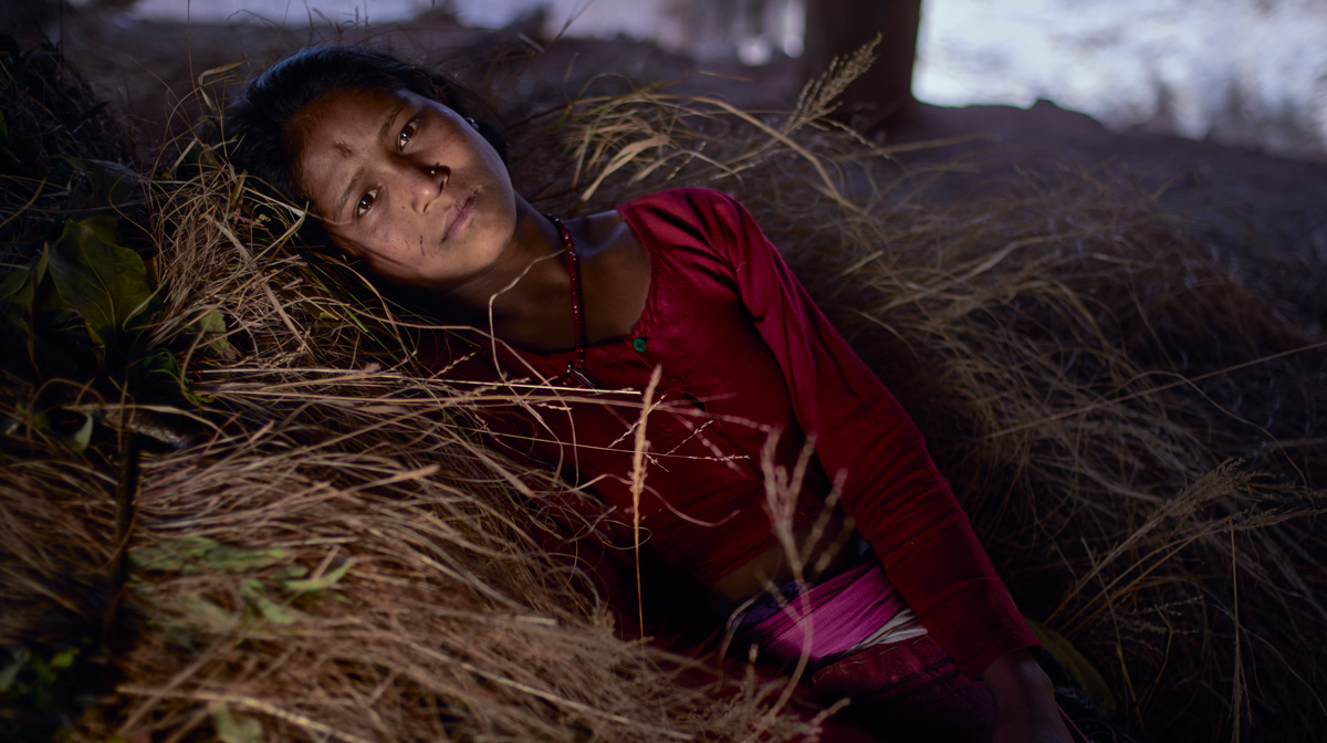 Girl laying in hay