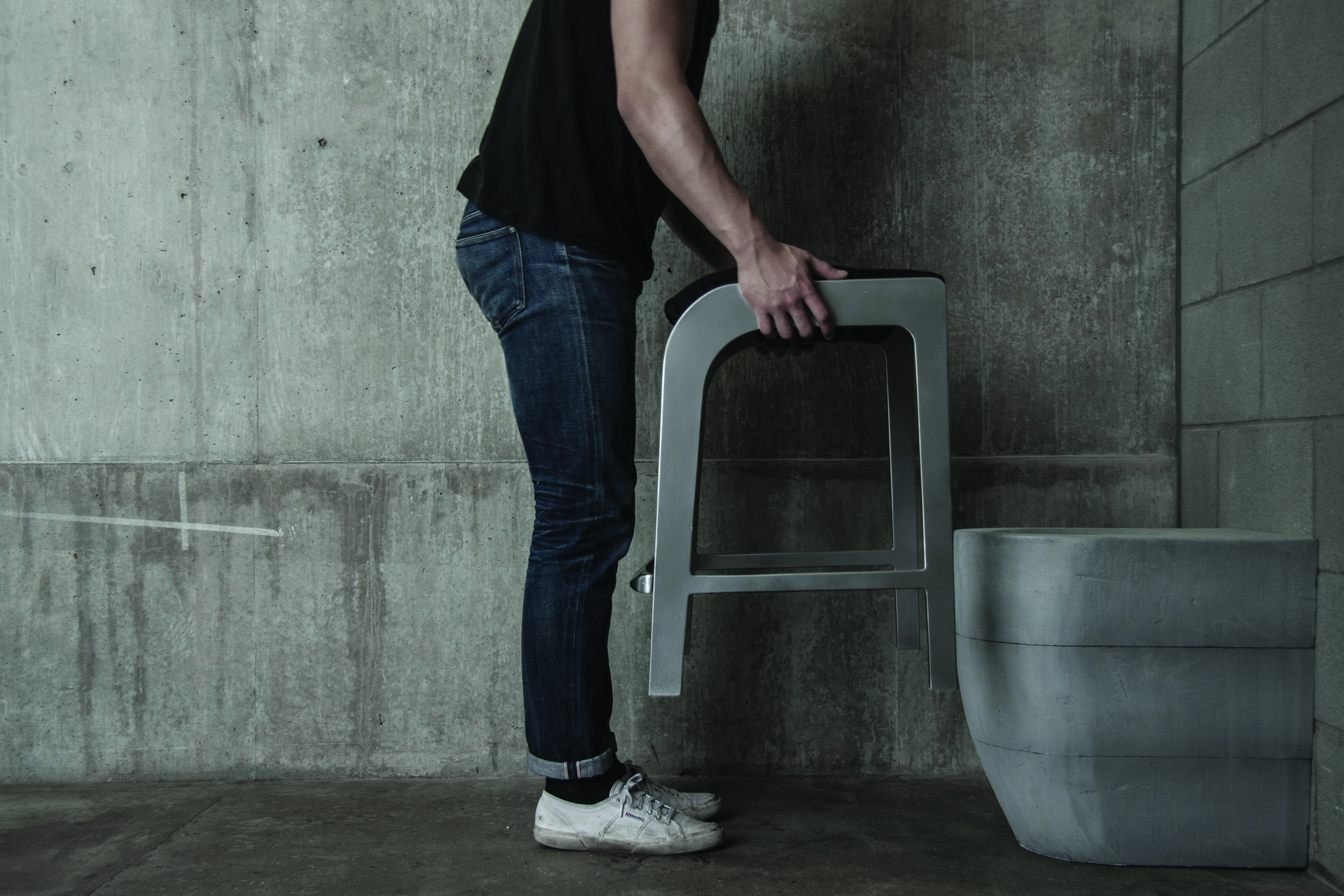 Man holding furniture over toilet