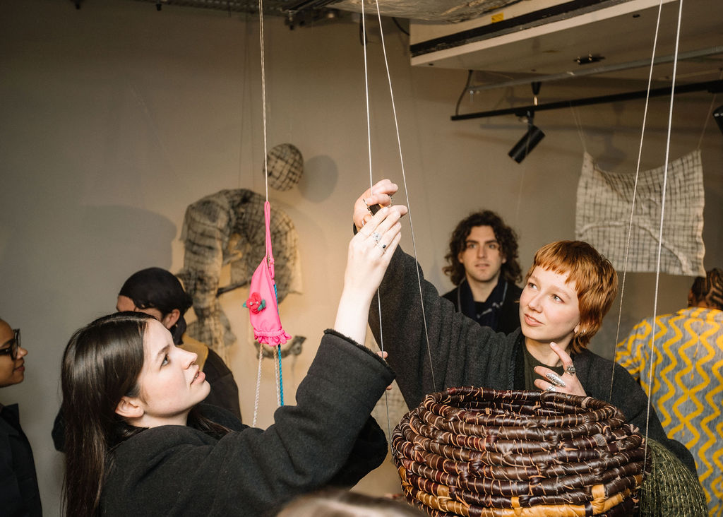 An image of students interacting with an art installation