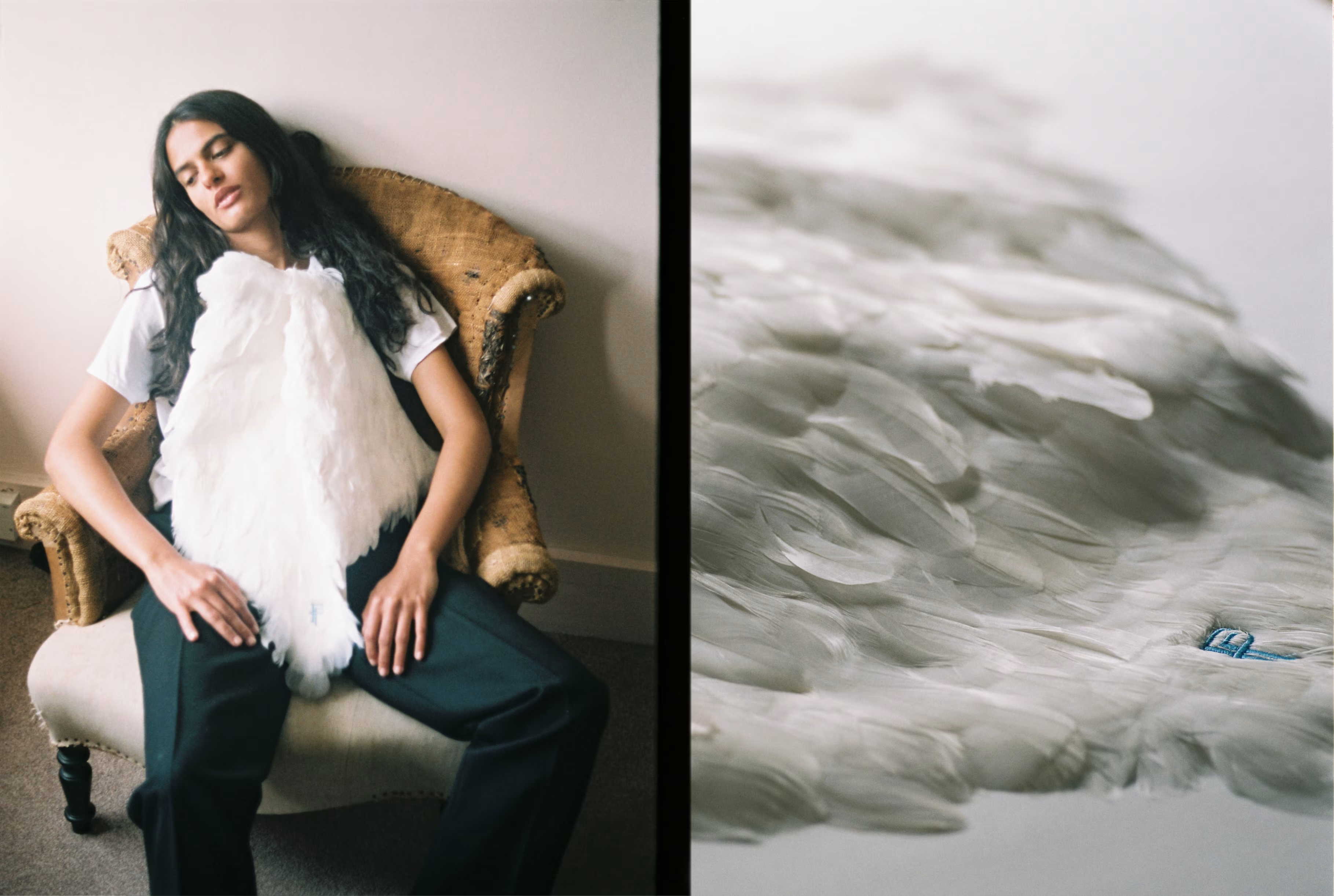 An image of a model sitting on a chair with wings on her chest