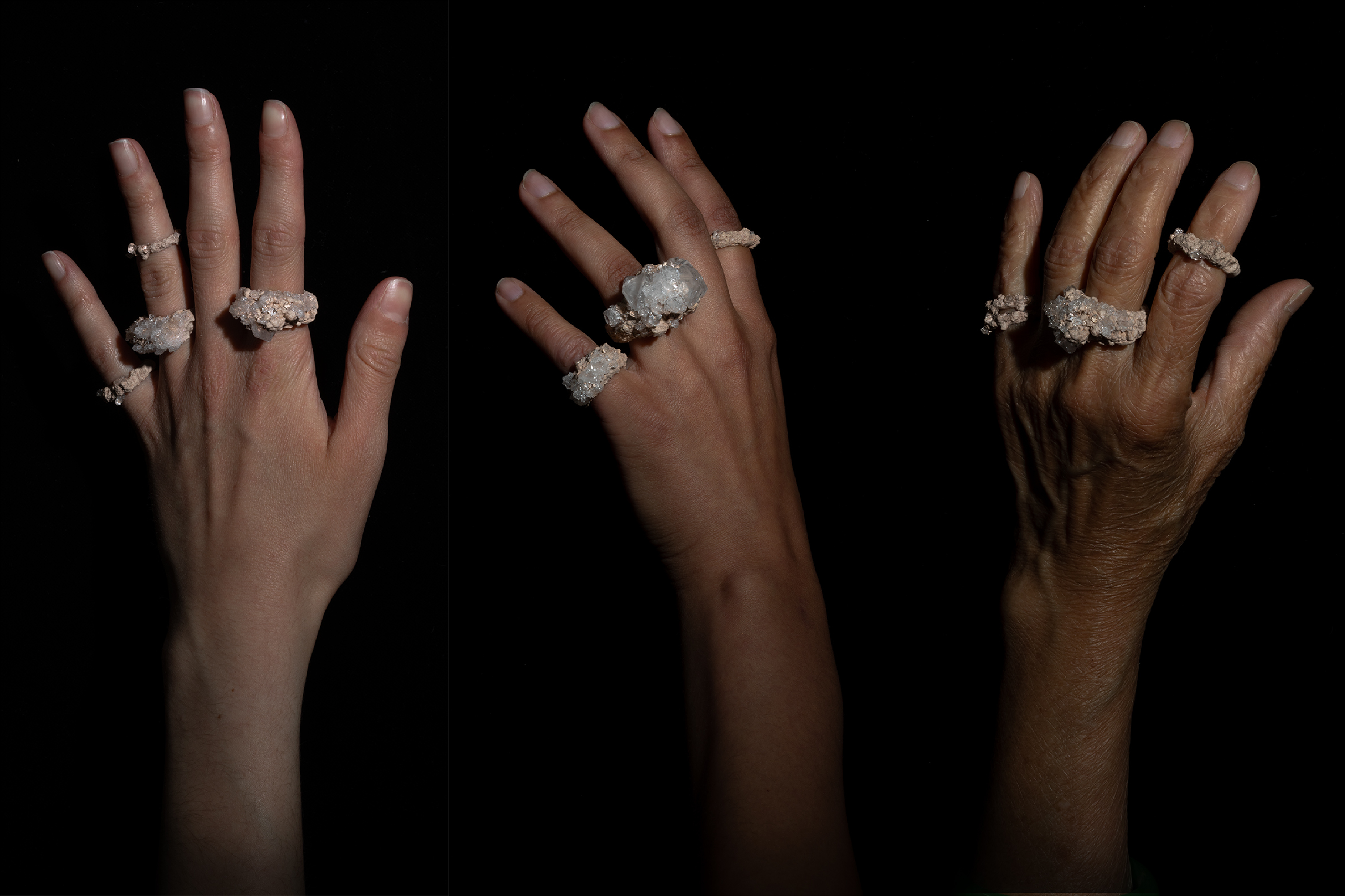 Three hands against a black background wearing 3 rings each.