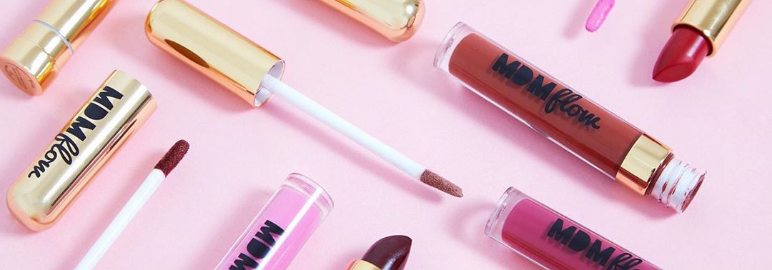 Combination of different colourful lipsticks on pink background