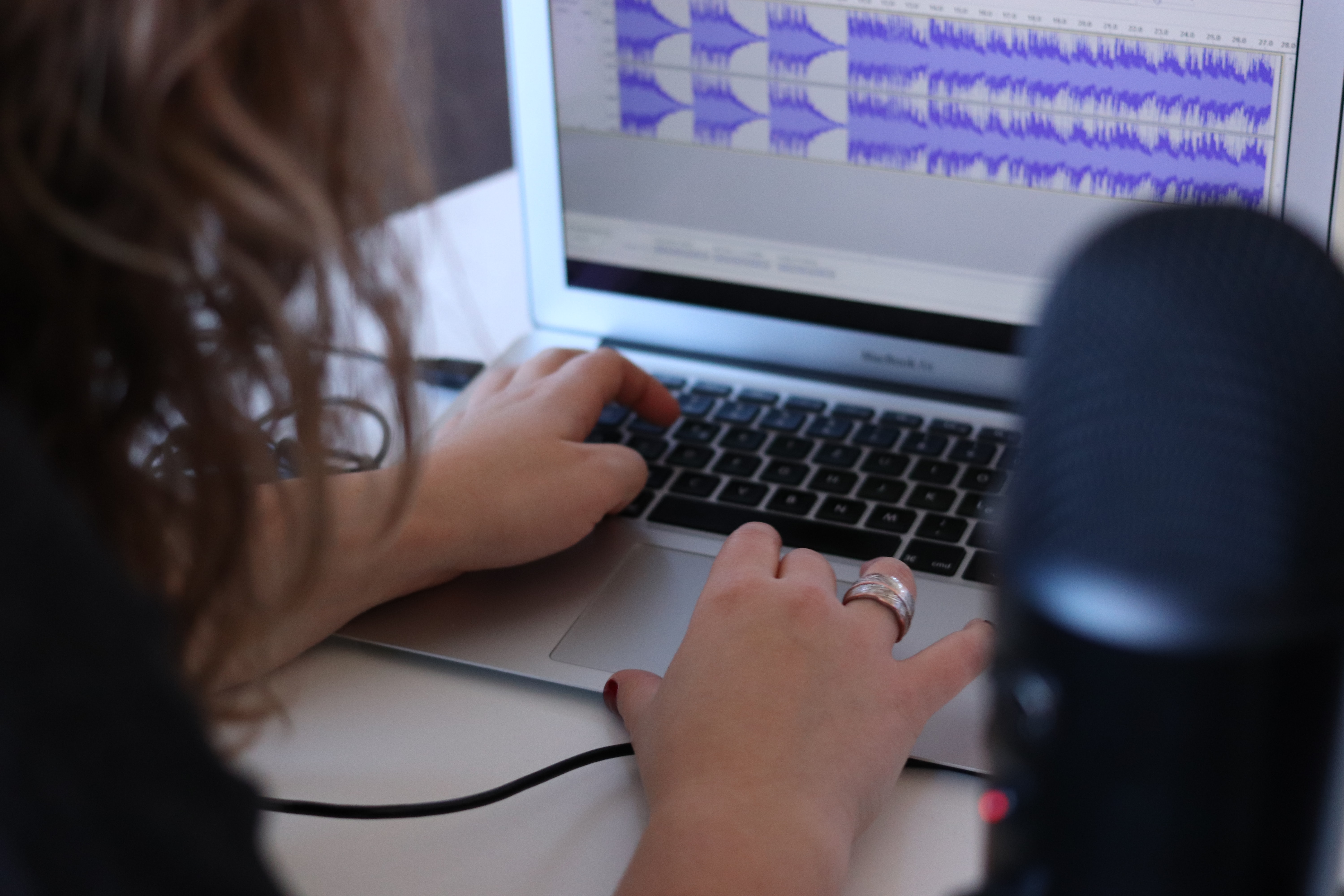 a person editing audio on a computer