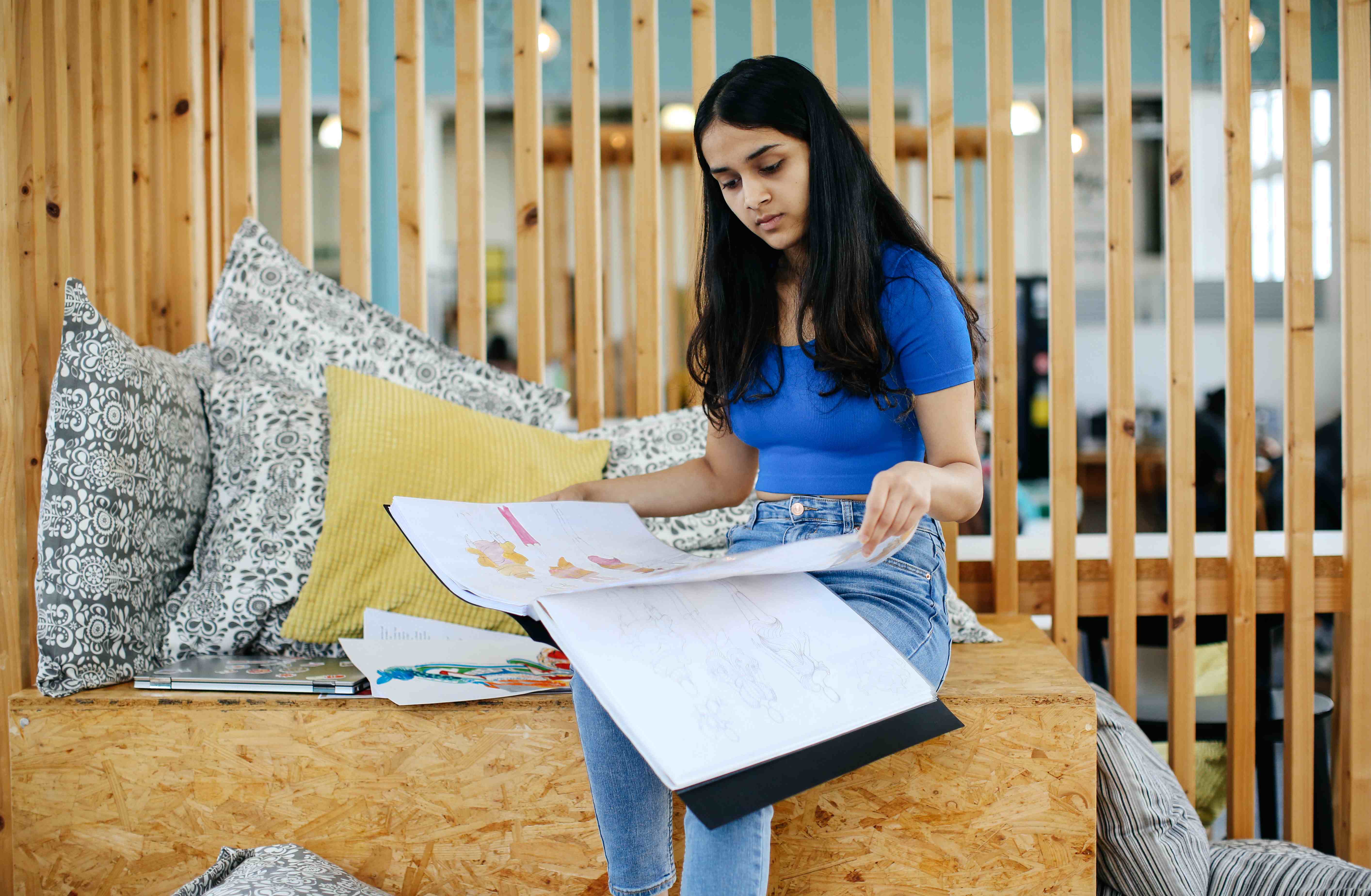 Photo of a person sitting and reading in the library