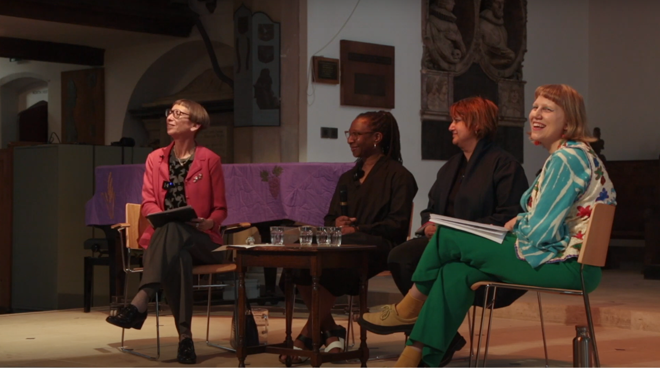 Four people sit side by side on a panel, from left to right: Professor Reina Lewis, Dr Christine Checinska, Humeera Dar, and Alisa Ruzavina